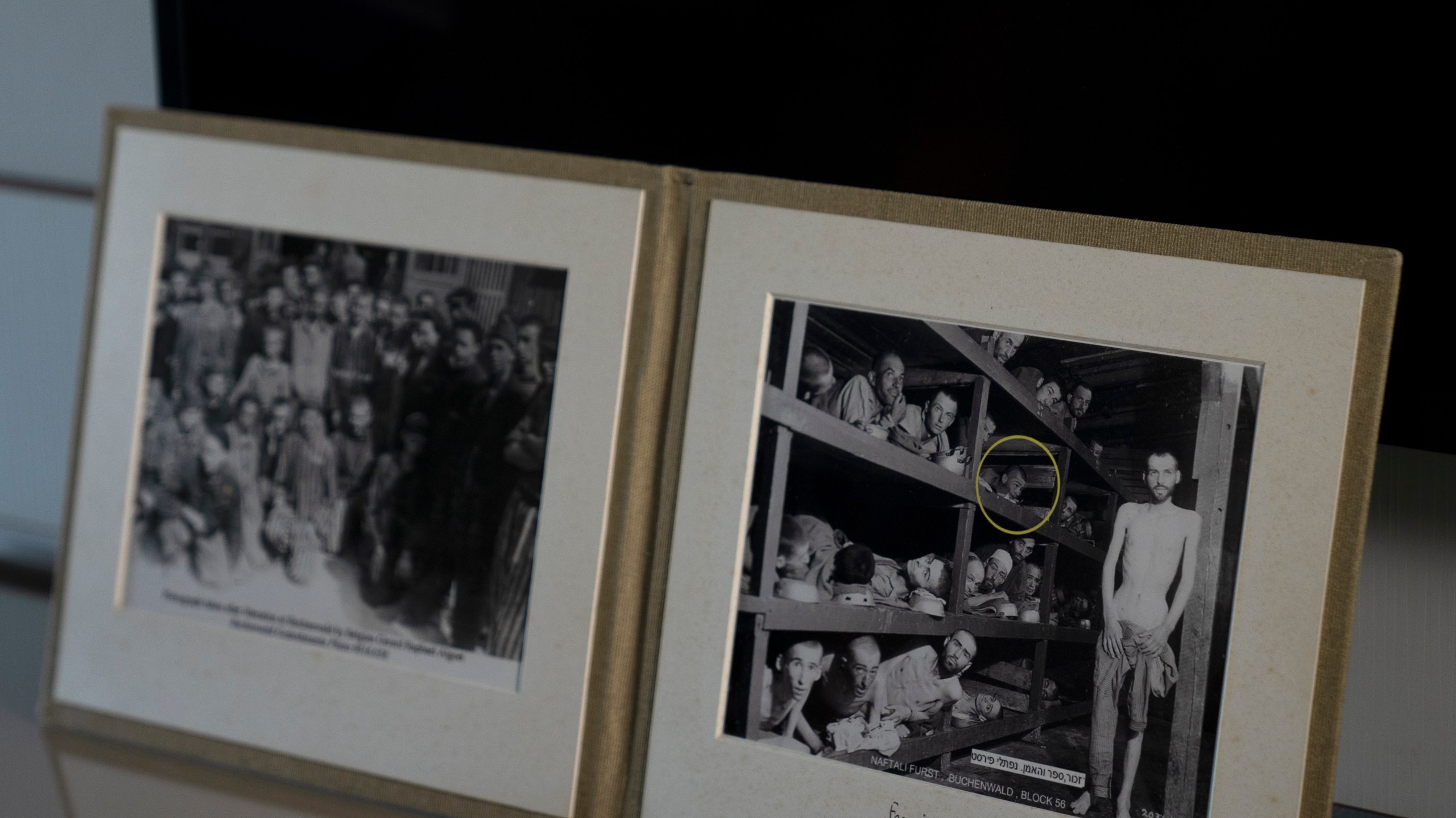 A photo of Holocaust survivor Naftali Fürst, circled in yellow, was taken by U.S. Army Pvt. H. Miller in April 1945 during the liberation of Buchenwald concentration camp, and is displayed in Fürst's home in Haifa, Israel, Tuesday, Jan. 14, 2025. (AP Photo/Maya Alleruzzo)