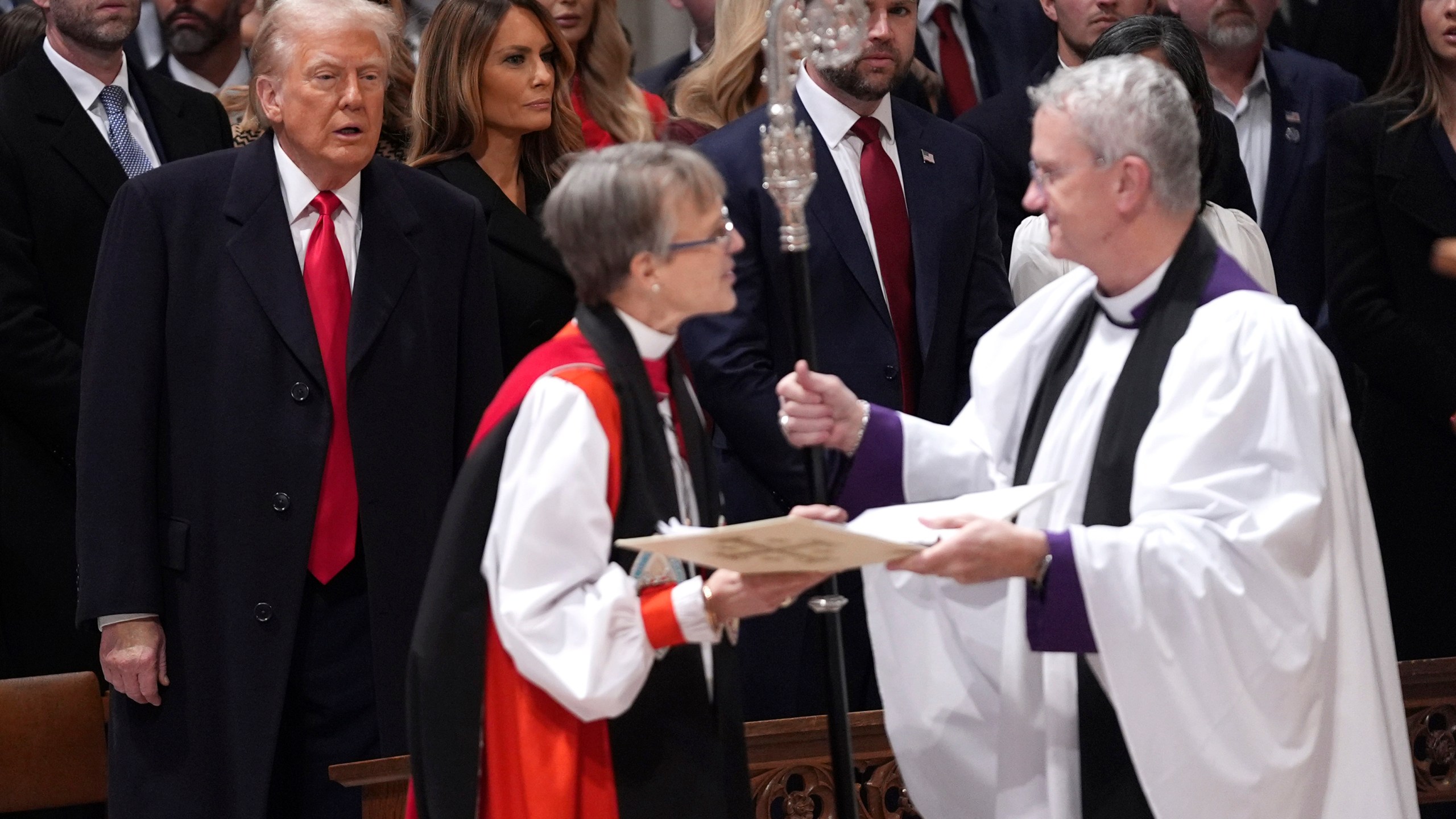 President Donald Trump, from left, watches as Rev. Mariann Budde arrives at the national prayer service at the Washington National Cathedral, Tuesday, Jan. 21, 2025, in Washington. (AP Photo/Evan Vucci)