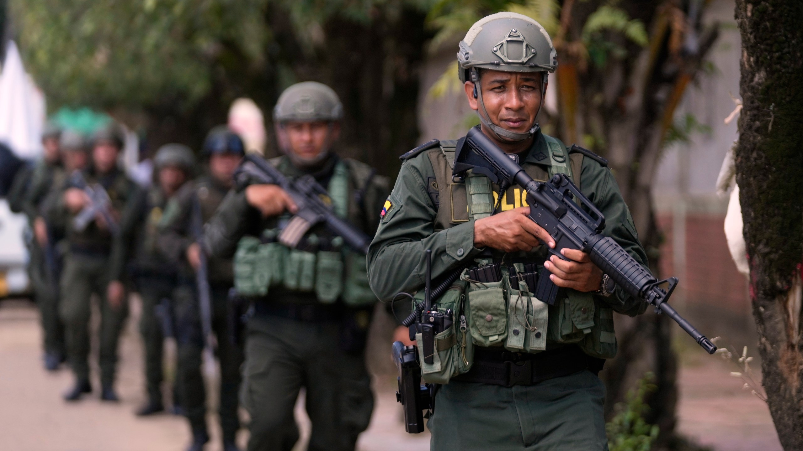 Police patrol in Tibu, Colombia, Tuesday, Jan. 21, 2025, following guerrilla attacks that have killed dozens of people and forced thousands to flee their homes in the Catatumbo region. (AP Photo/Fernando Vergara)