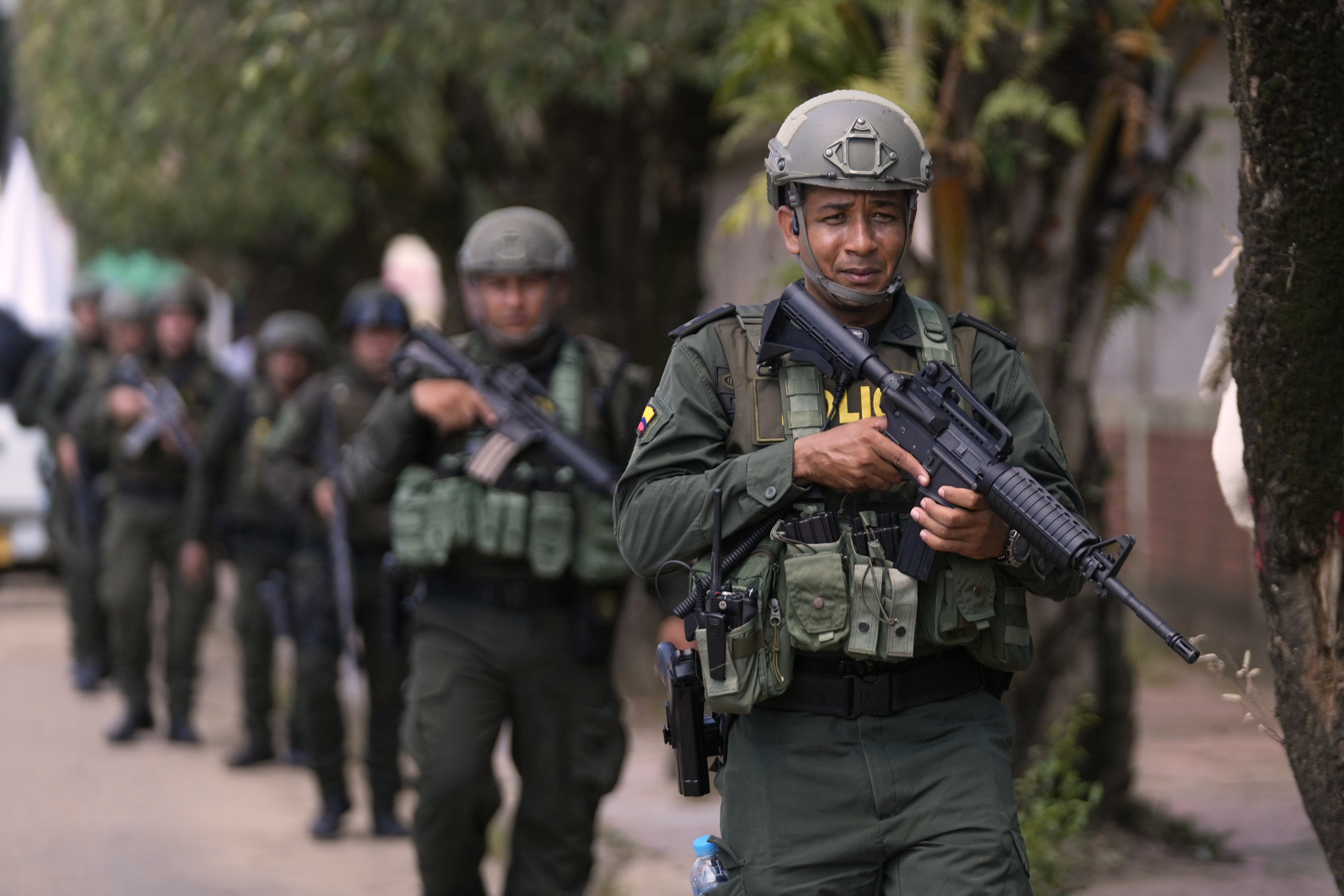 Police patrol in Tibu, Colombia, Tuesday, Jan. 21, 2025, following guerrilla attacks that have killed dozens of people and forced thousands to flee their homes in the Catatumbo region. (AP Photo/Fernando Vergara)