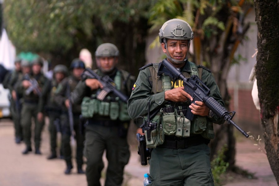 Police patrol in Tibu, Colombia, Tuesday, Jan. 21, 2025, following guerrilla attacks that have killed dozens of people and forced thousands to flee their homes in the Catatumbo region. (AP Photo/Fernando Vergara)