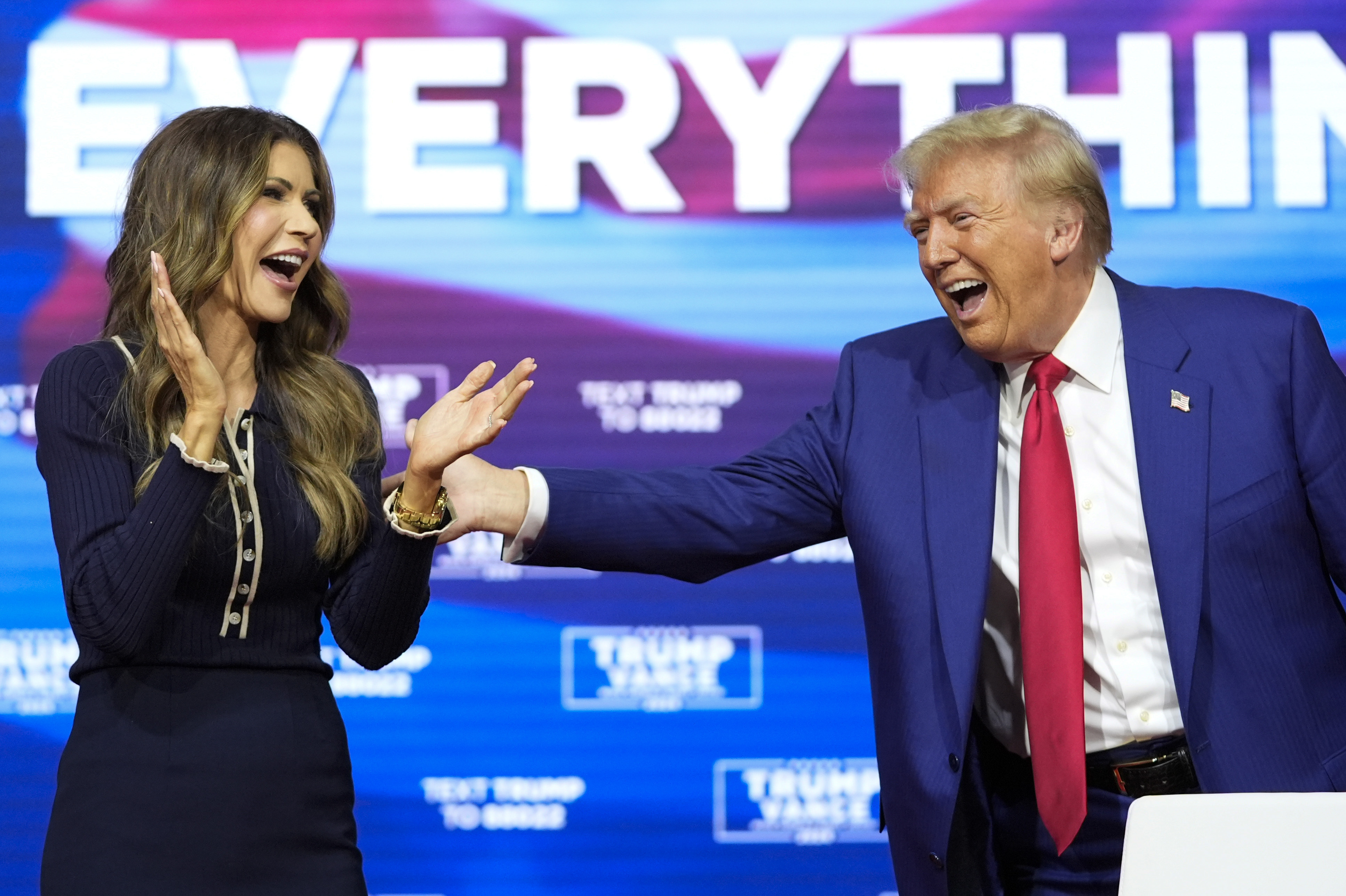 FILE - Republican presidential nominee former President Donald Trump reacts with South Dakota Gov. Kristi Noem after dancing to the song "Y.M.C.A." at a campaign town hall at the Greater Philadelphia Expo Center & Fairgrounds, Oct. 14, 2024, in Oaks, Pa. (AP Photo/Alex Brandon, File)