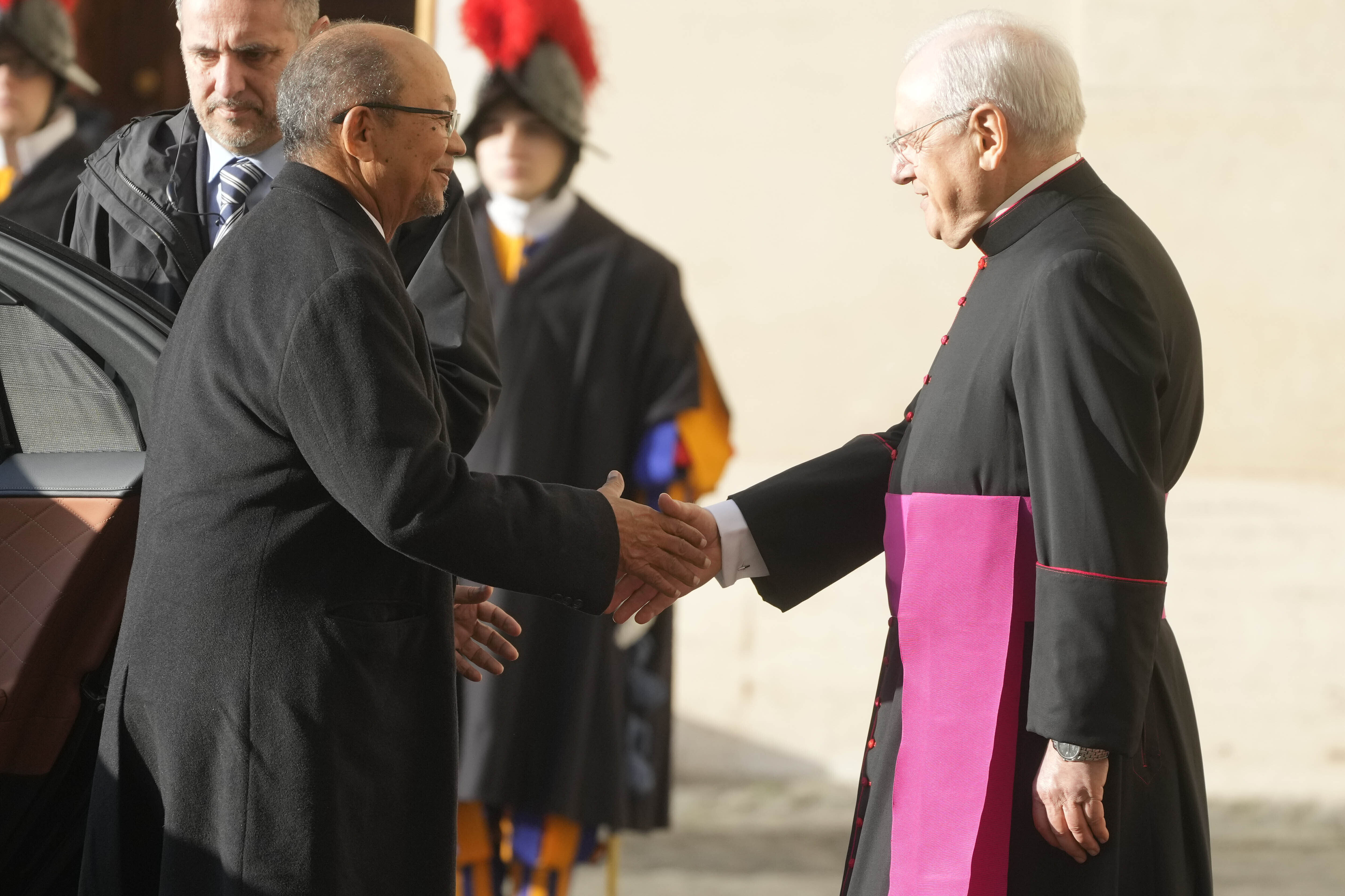 Leslie Voltaire, the president of Haiti's Transition Council, left, is welcomed by Father Leonardo Sapienza ahead of his meeting with Pope Francis at the Vatican, Saturday, Jan. 25, 2025. (AP Photo/Gregorio Borgia)