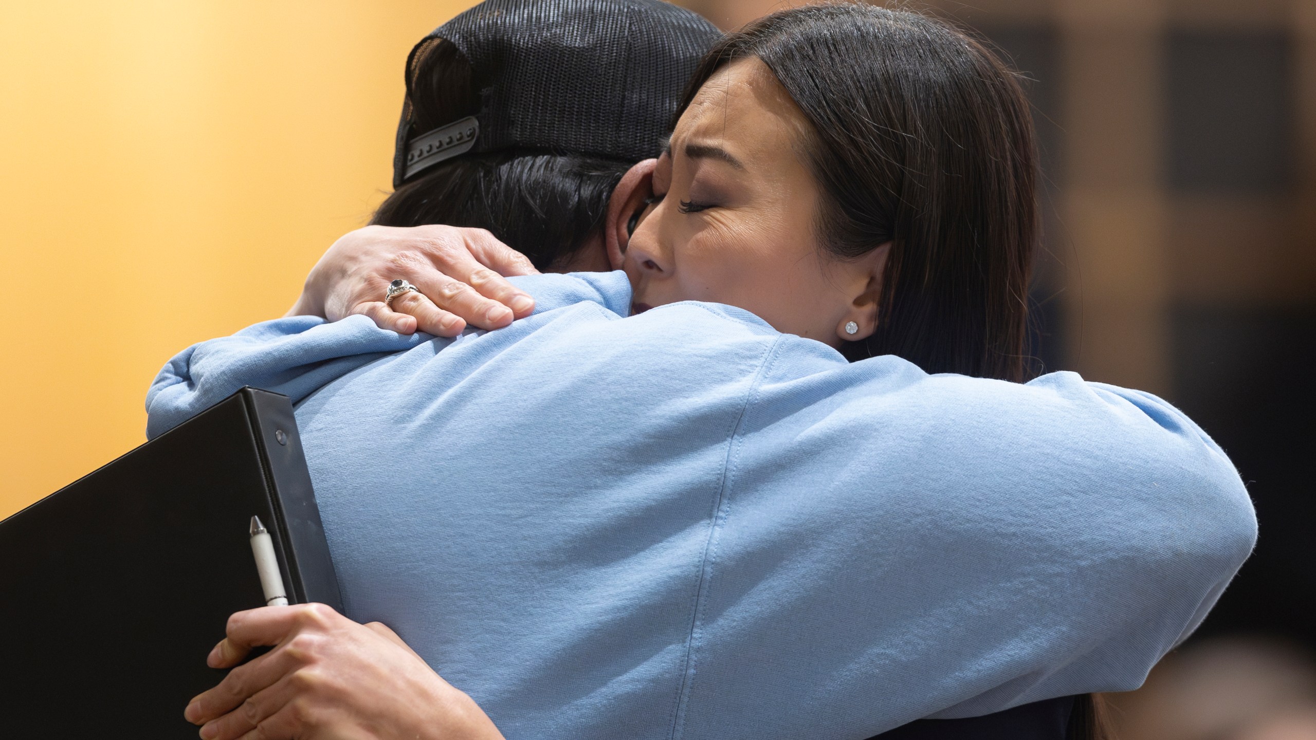 Wichita mayor Lily Wu hugs Pastor Albert Paredes during a prayer vigil in Wichita, Kan., on Thursday, Jan. 30, 2025, for those affected by the crash of American Airlines flight 5342 near Washington the day before. (AP Photo/Travis Heying)