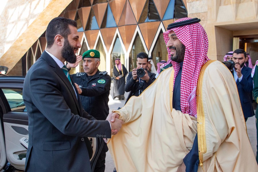 In this photo provided by the Saudi Ministry of Media, Saudi Crown Prince Mohammed bin Salman greets Syria's interim President Ahmad al-Sharaa, left, during his arrival at the royal palace in Riyadh, Saudi Arabia, Sunday, Feb. 2, 2025. (Saudi Ministry of Media via AP)