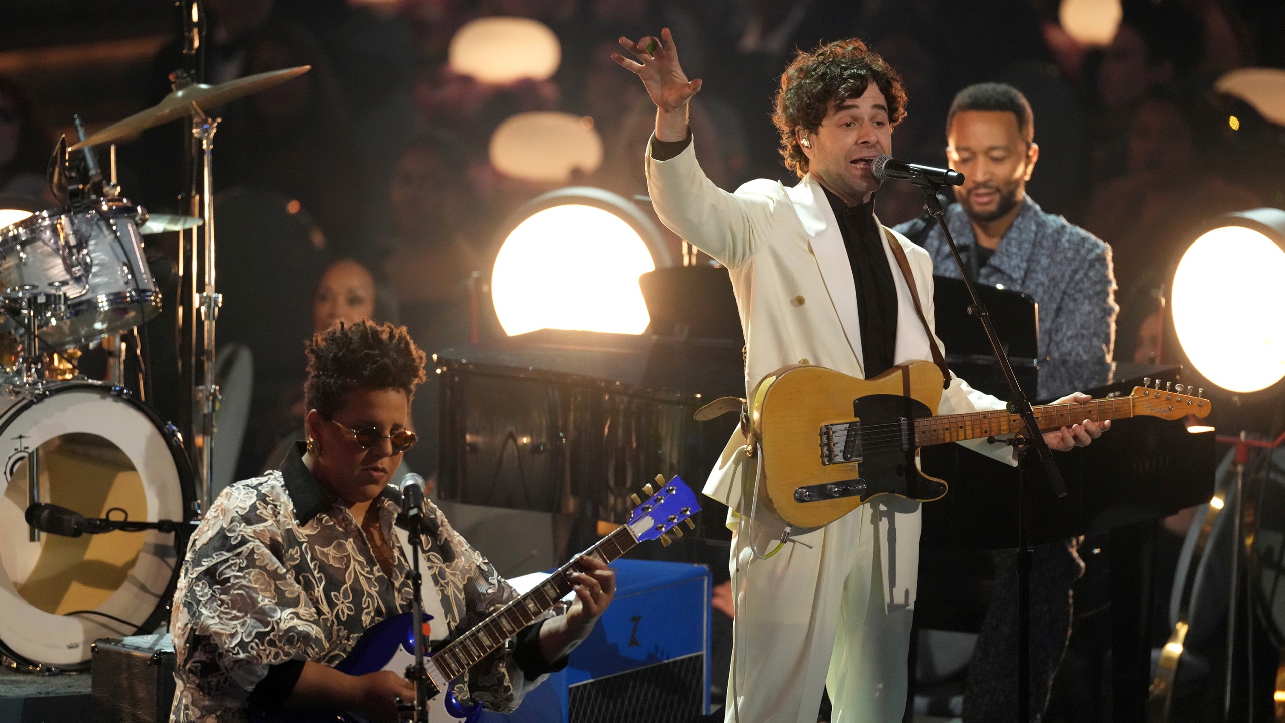 Brittany Howard, from left, Tony Goldsmith, and John Legend perform "I Love L.A." during the 67th annual Grammy Awards on Sunday, Feb. 2, 2025, in Los Angeles. (AP Photo/Chris Pizzello)