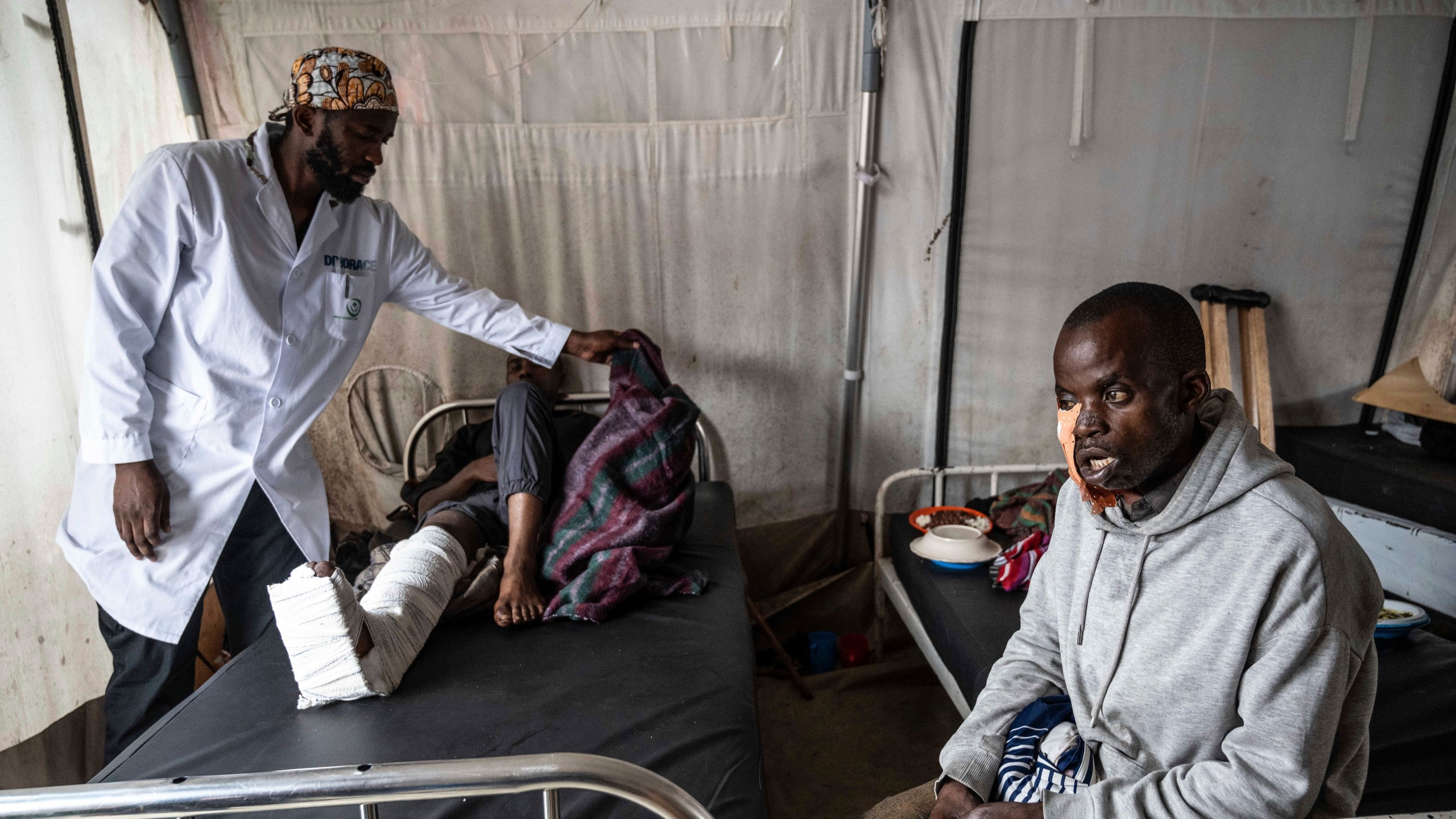 Medics treat a man wounded during fighting between Congolese government troops and M23 rebel forces in Goma's Kyeshero hospital Saturday, Feb. 1, 2025. (AP Photo/Moses Sawasawa)