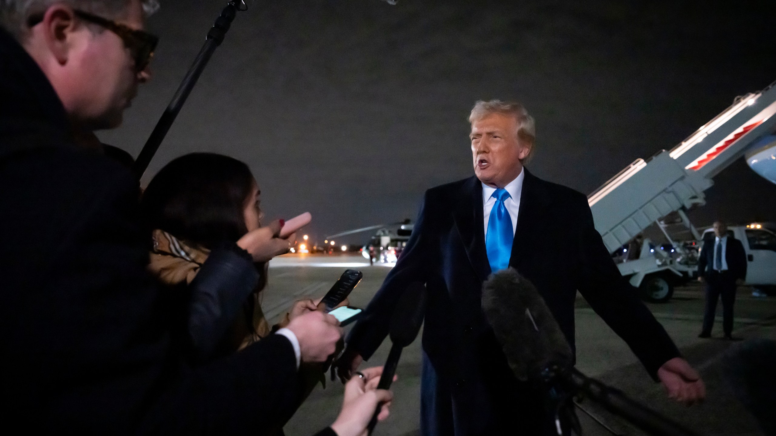 President Donald Trump speaks to reporters next to Air Force One after arriving back at Joint Base Andrews, Md., Sunday, Feb. 2, 2025. (AP Photo/Ben Curtis)