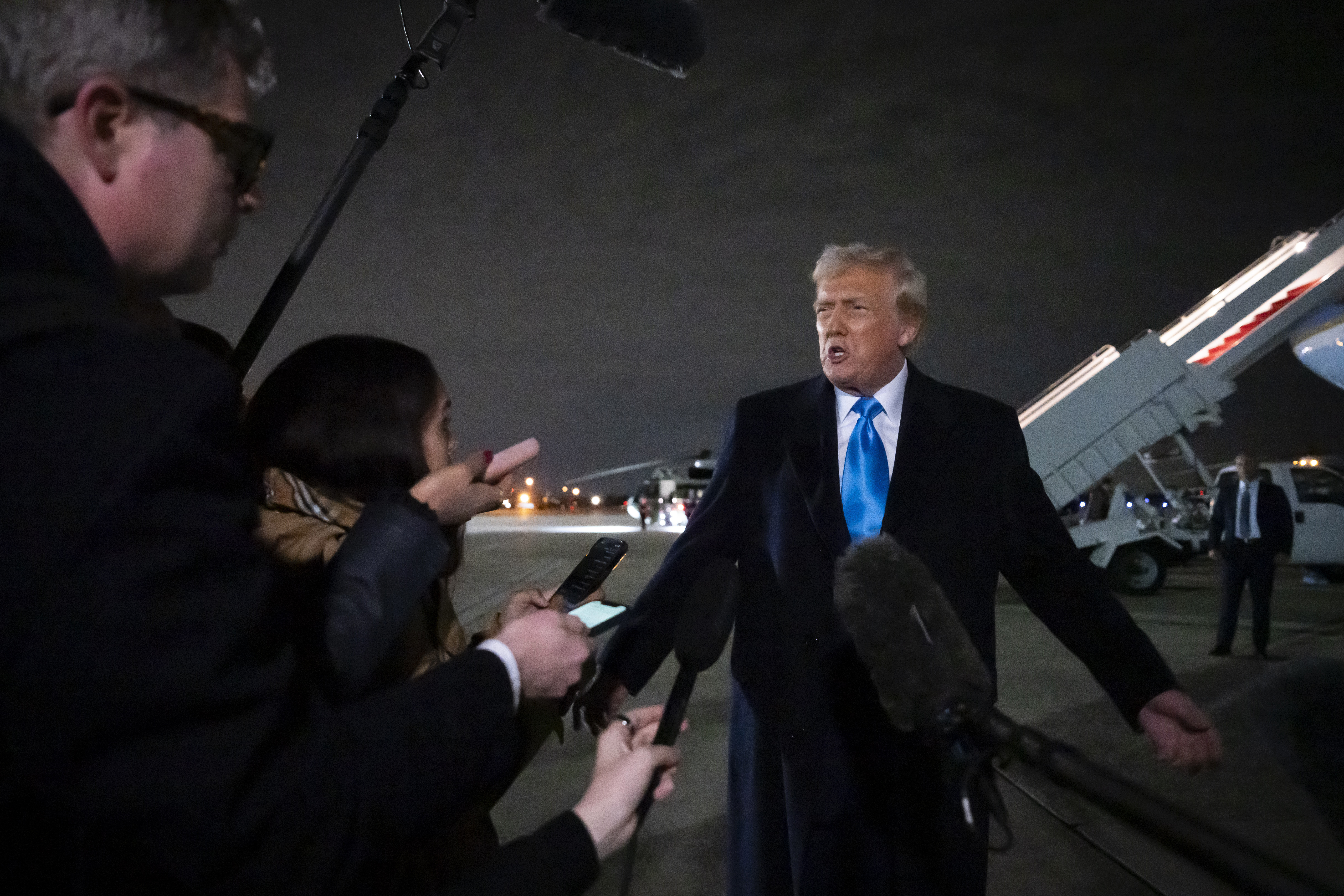 President Donald Trump speaks to reporters next to Air Force One after arriving back at Joint Base Andrews, Md., Sunday, Feb. 2, 2025. (AP Photo/Ben Curtis)