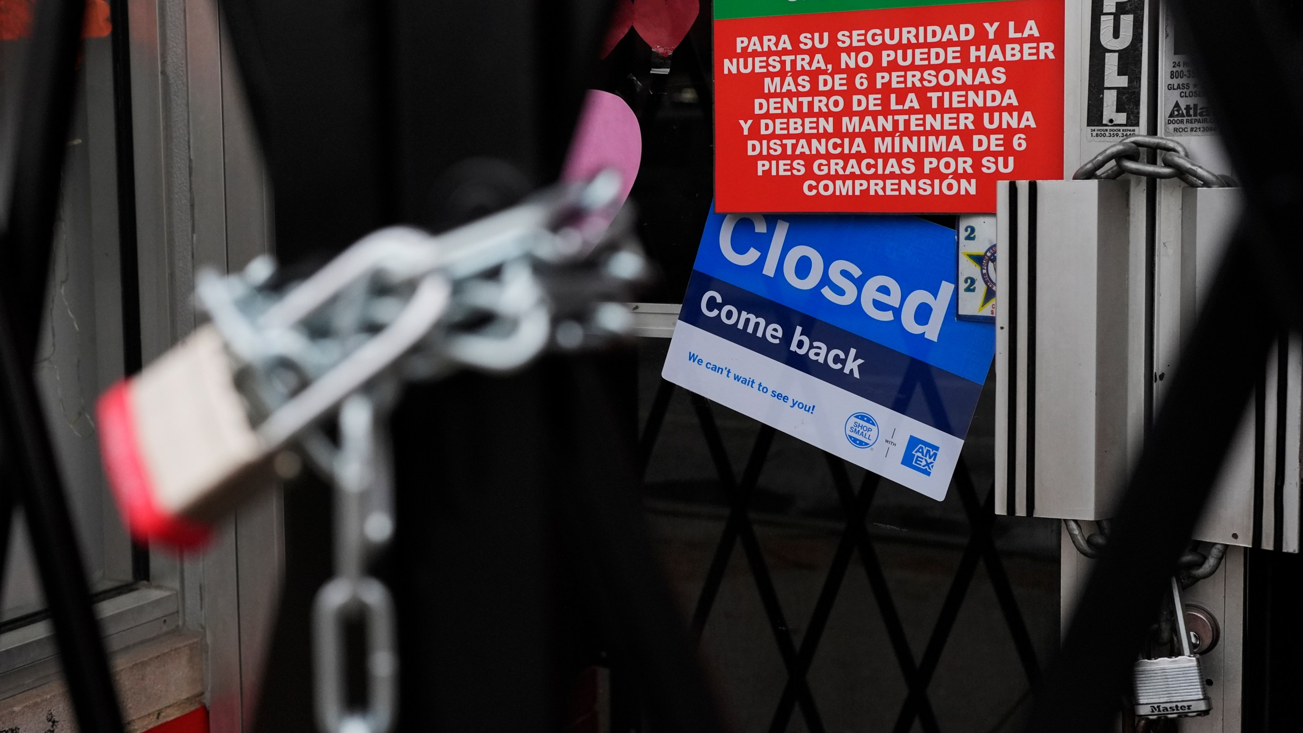 A closed sign is displayed at a mini grocery store in the Little Village neighborhood of Chicago, Monday, Feb. 3, 2025. (AP Photo/Nam Y. Huh)