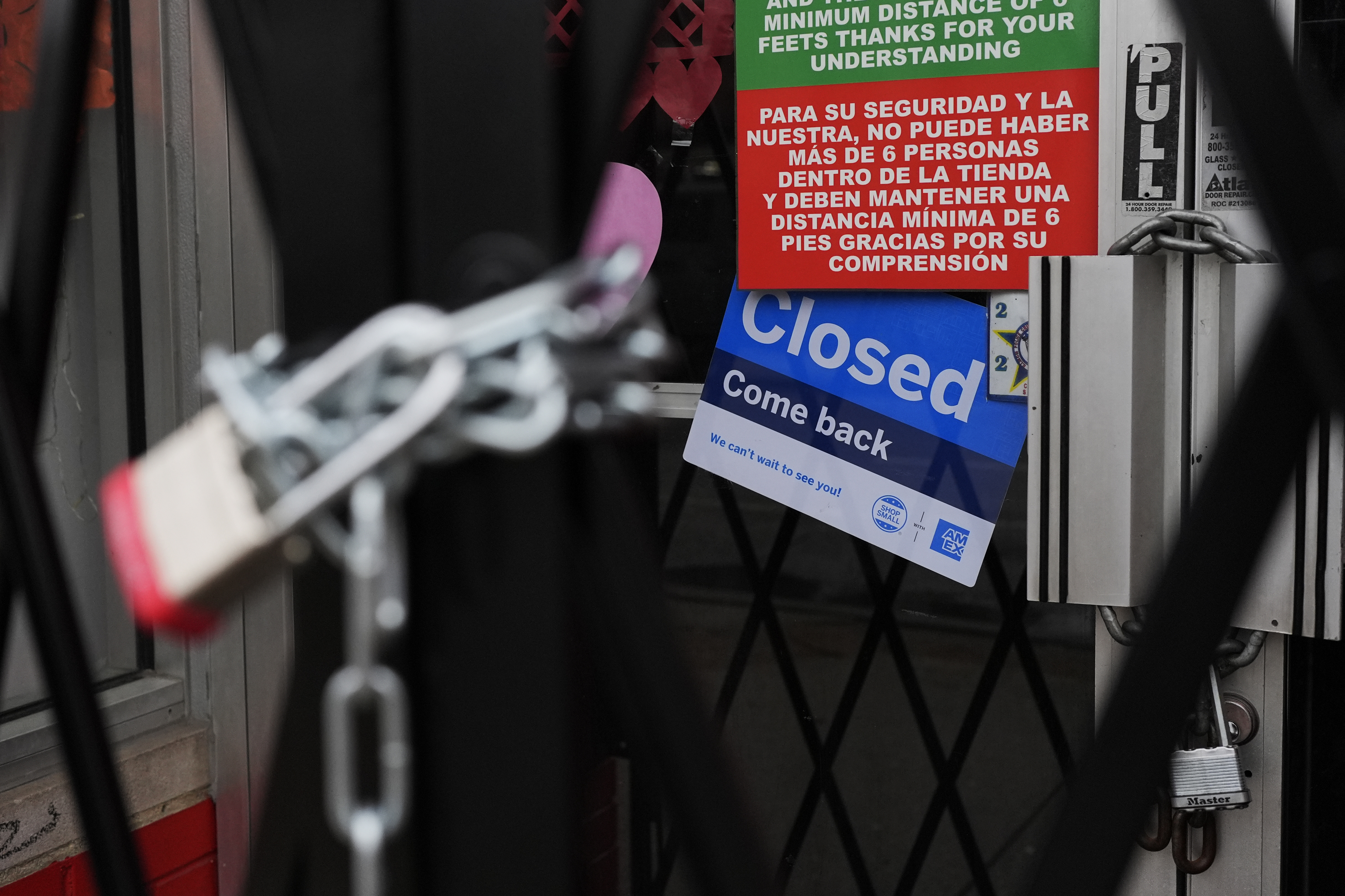 A closed sign is displayed at a mini grocery store in the Little Village neighborhood of Chicago, Monday, Feb. 3, 2025. (AP Photo/Nam Y. Huh)