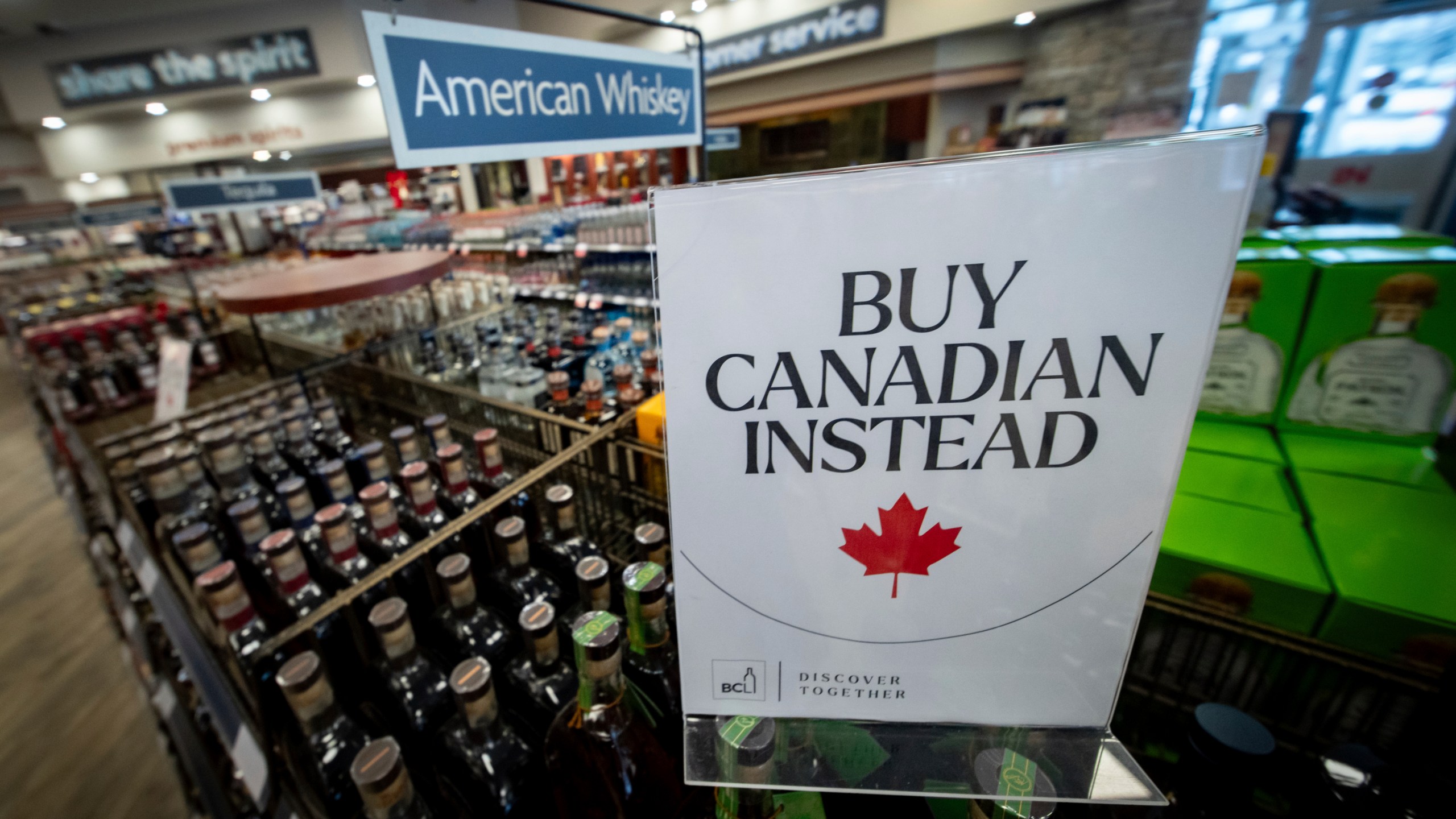 A sign is placed in front of the American whiskey section at a B.C. liquor store after top selling American made products have been removed from shelves in Vancouver, B.C., Sunday, Feb. 2, 2025. (Ethan Cairns/The Canadian Press via AP)