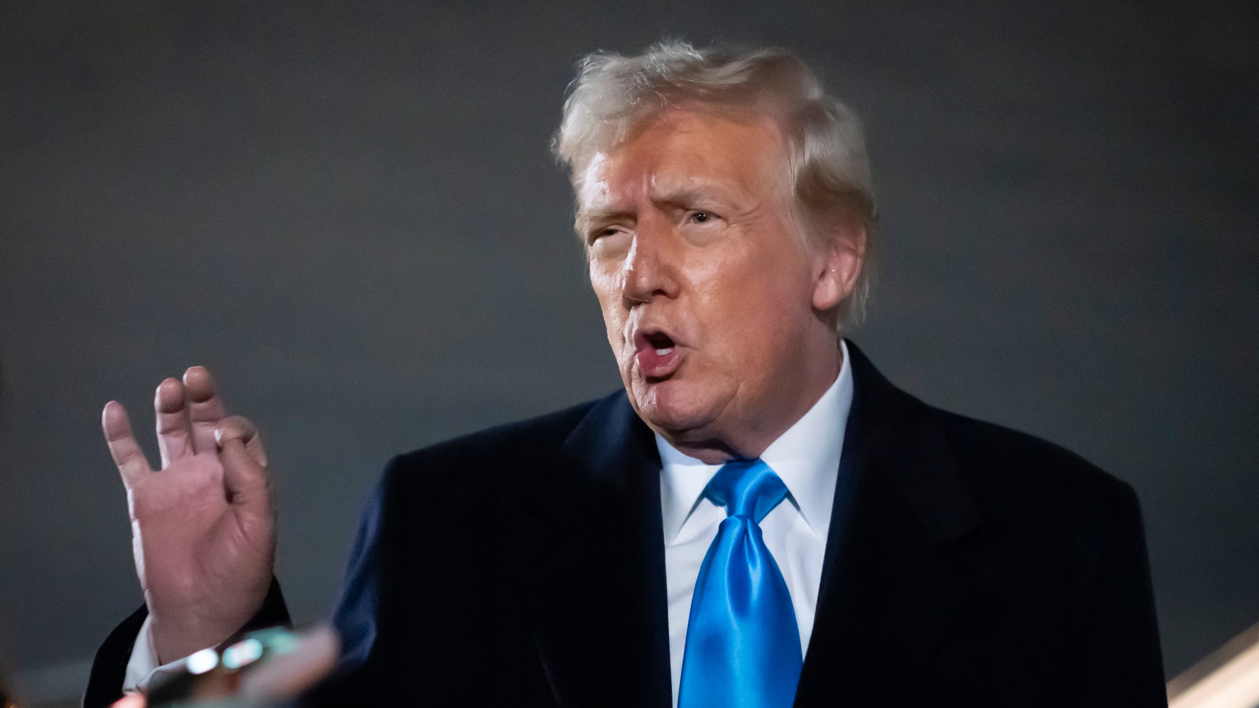 President Donald Trump speaks to reporters next to Air Force One after arriving back at Joint Base Andrews, Md., Sunday, Feb. 2, 2025. (AP Photo/Ben Curtis)