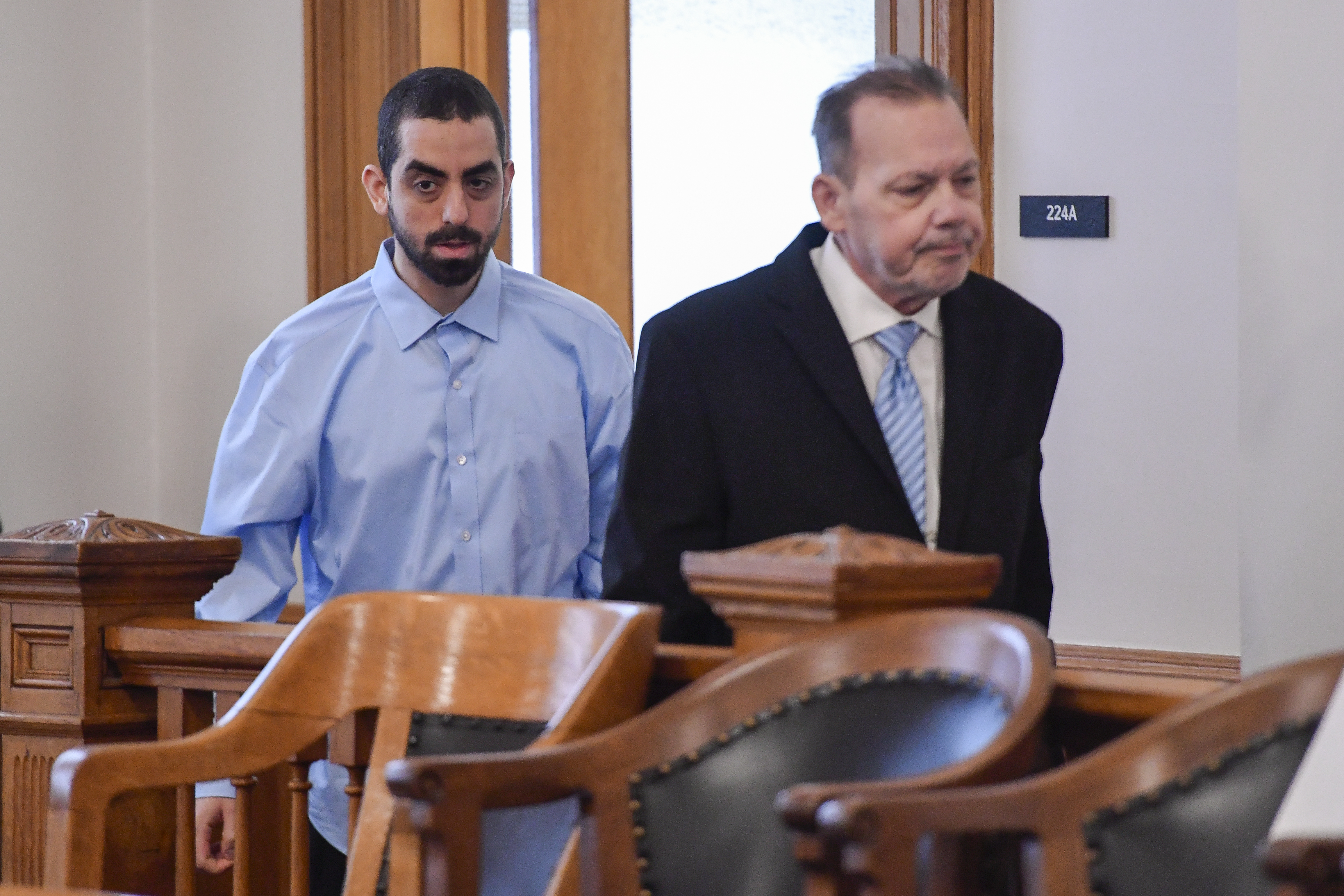 Hadi Matar, left, charged with severely injuring author Salman Rushdie in a 2022 knife attack, is led into Chautauqua County court by public defender Nathaniel Barone before the start of jury selection in Mayville, N.Y., Tuesday, Feb. 4, 2025. (AP Photo/Adrian Kraus)