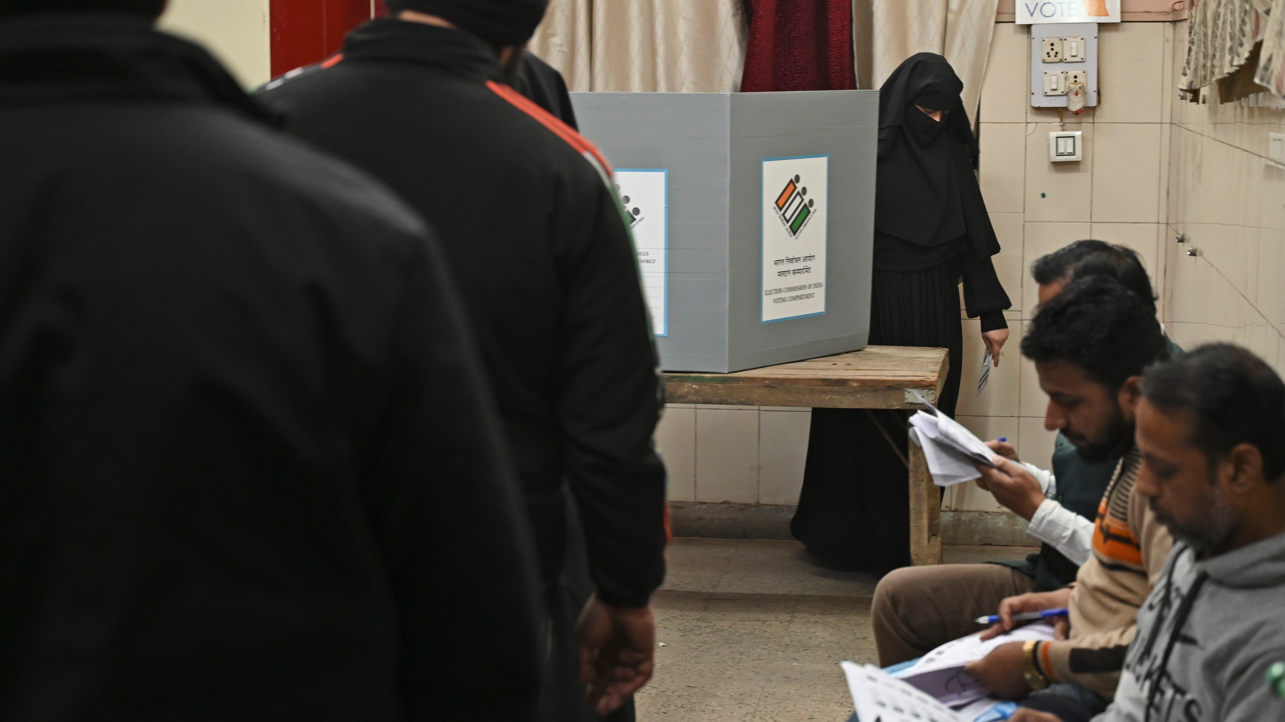 A Muslim woman returns after casting her vote for Delhi state election at a polling booth in New Delhi, India, Wednesday, Feb.5, 2025. (AP Photo)