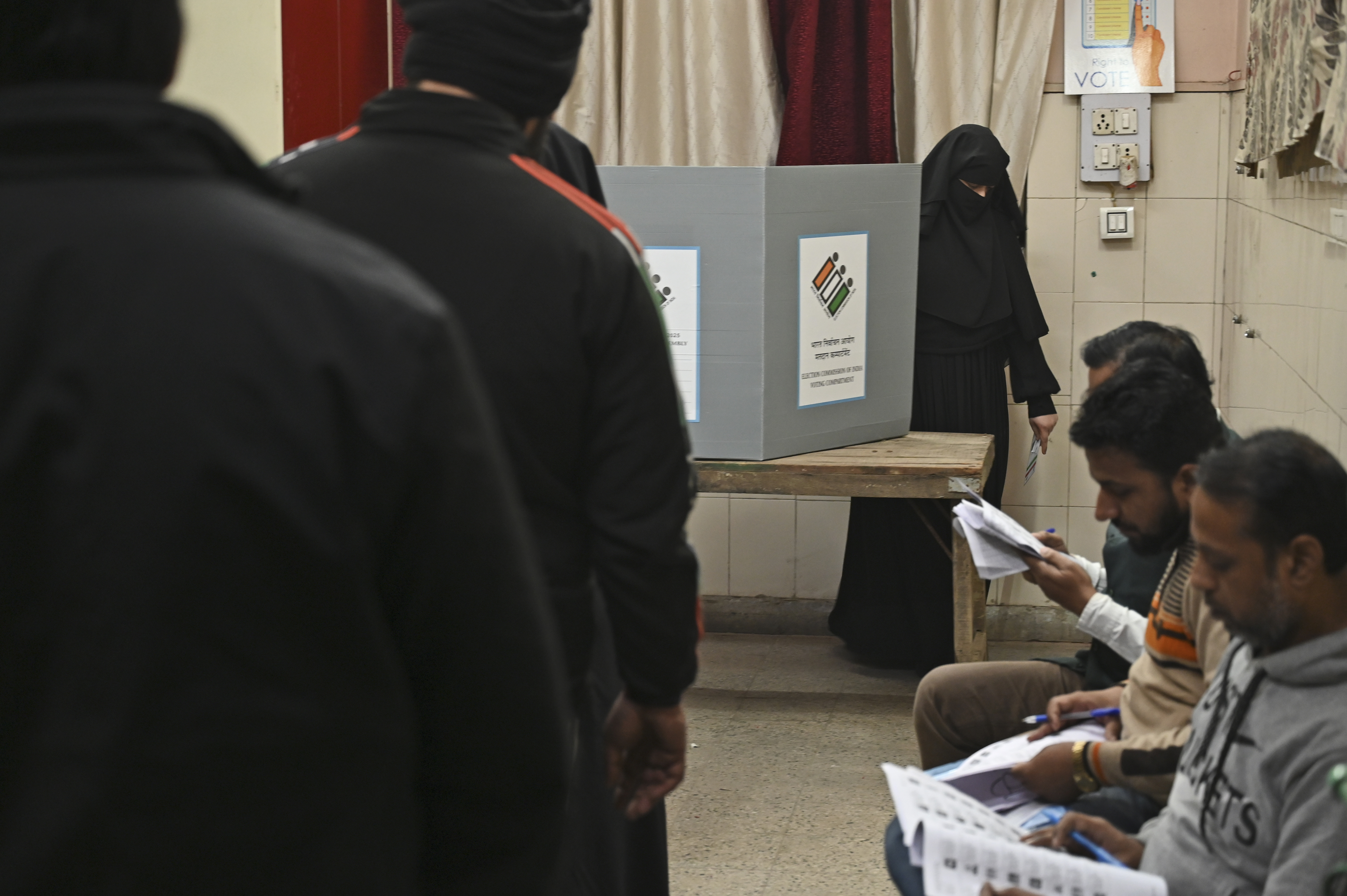 A Muslim woman returns after casting her vote for Delhi state election at a polling booth in New Delhi, India, Wednesday, Feb.5, 2025. (AP Photo)