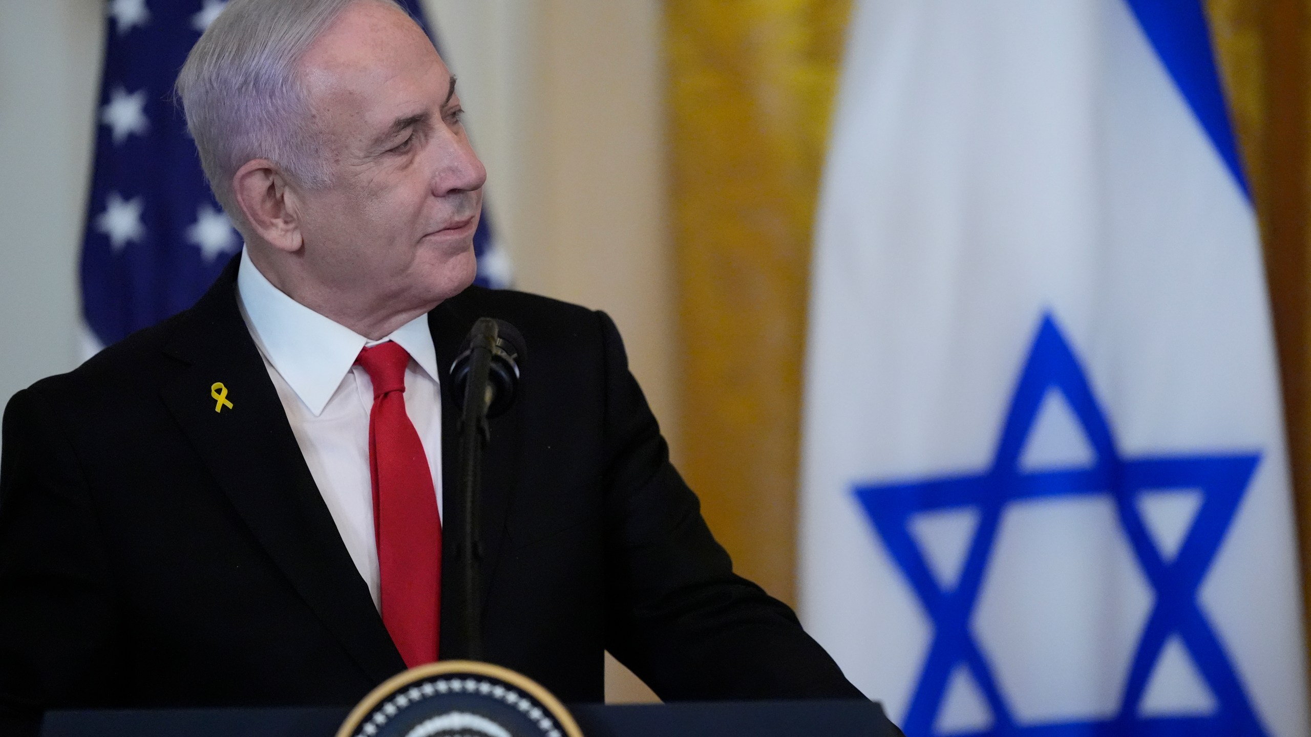 Israeli Prime Minister Benjamin Netanyahu listens as President Donald Trump speaks during a news conference in the East Room of the White House, Tuesday, Feb. 4, 2025, in Washington. (AP Photo/Alex Brandon)