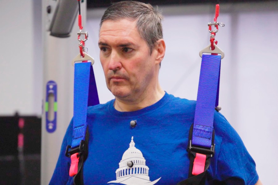 This image from video provided by UPMC and University of Pittsburgh Health Sciences shows Doug McCullough, who has spinal muscular atrophy, during tests of experimental spinal cord stimulation to improve muscle function in Pittsburgh, on March 14, 2023. (UPMC, University of Pittsburgh Health Sciences via AP)