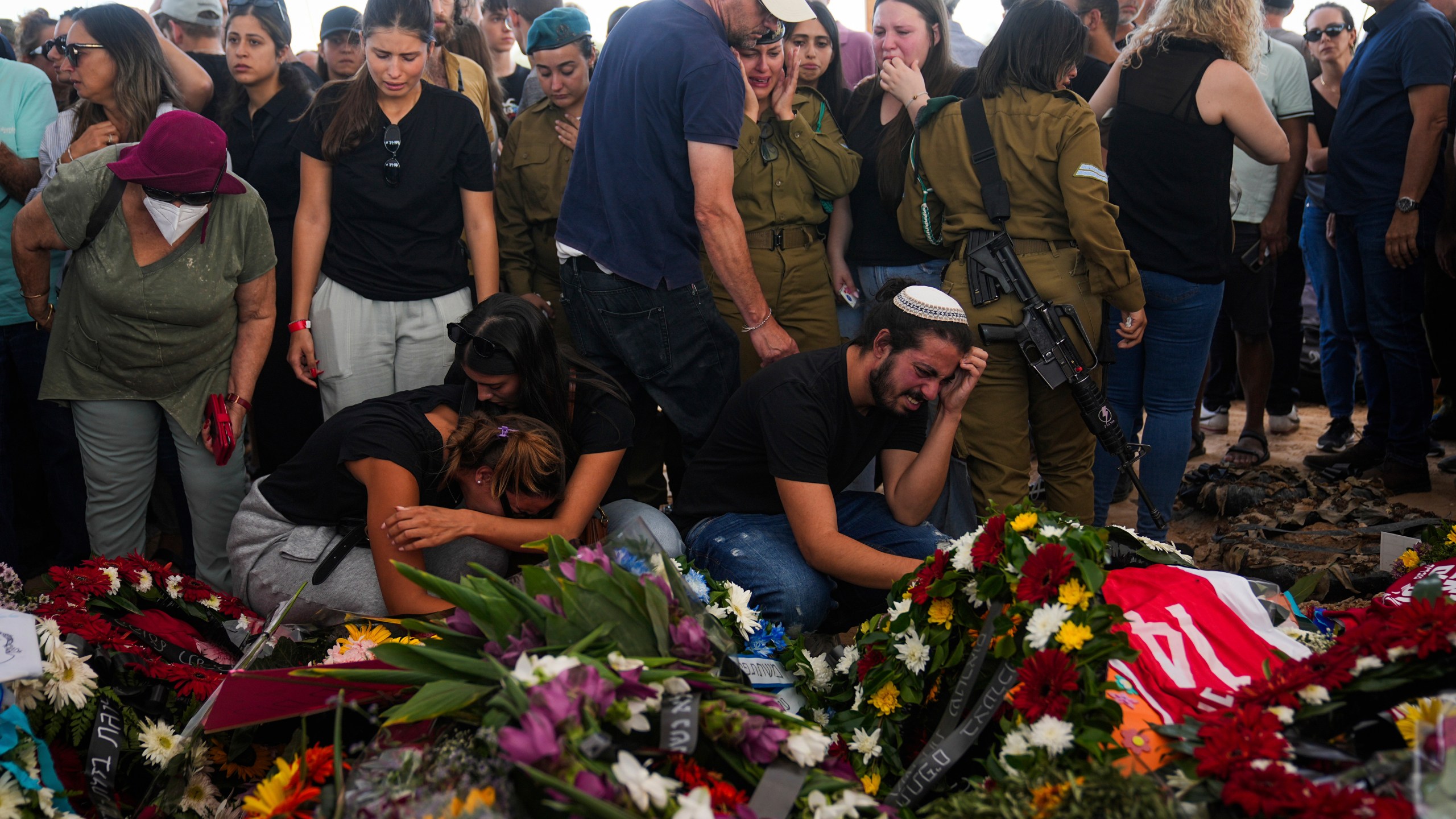 FILE - Mourners attend the funeral of the Kotz family in Gan Yavne, Israel, Oct. 17, 2023. (AP Photo/Ohad Zwigenber, File)