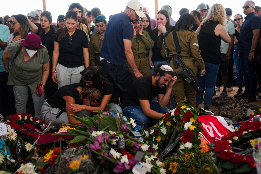 FILE - Mourners attend the funeral of the Kotz family in Gan Yavne, Israel, Oct. 17, 2023. (AP Photo/Ohad Zwigenber, File)