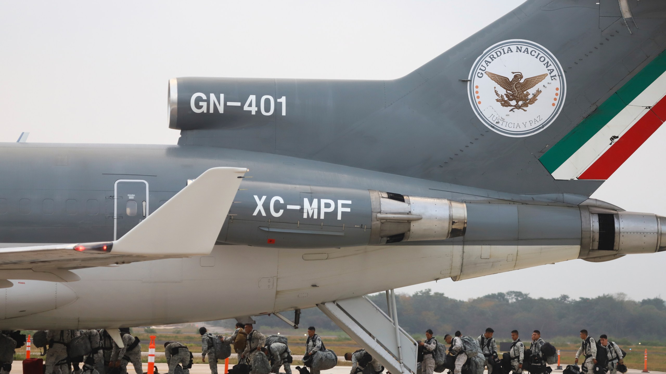 Mexican National Guards board an aircraft at the International Airport in Merida, Mexico, Tuesday, Feb. 4, 2025, to reinforce the country's northern border with the United States. (AP Photo/Martin Zetina)