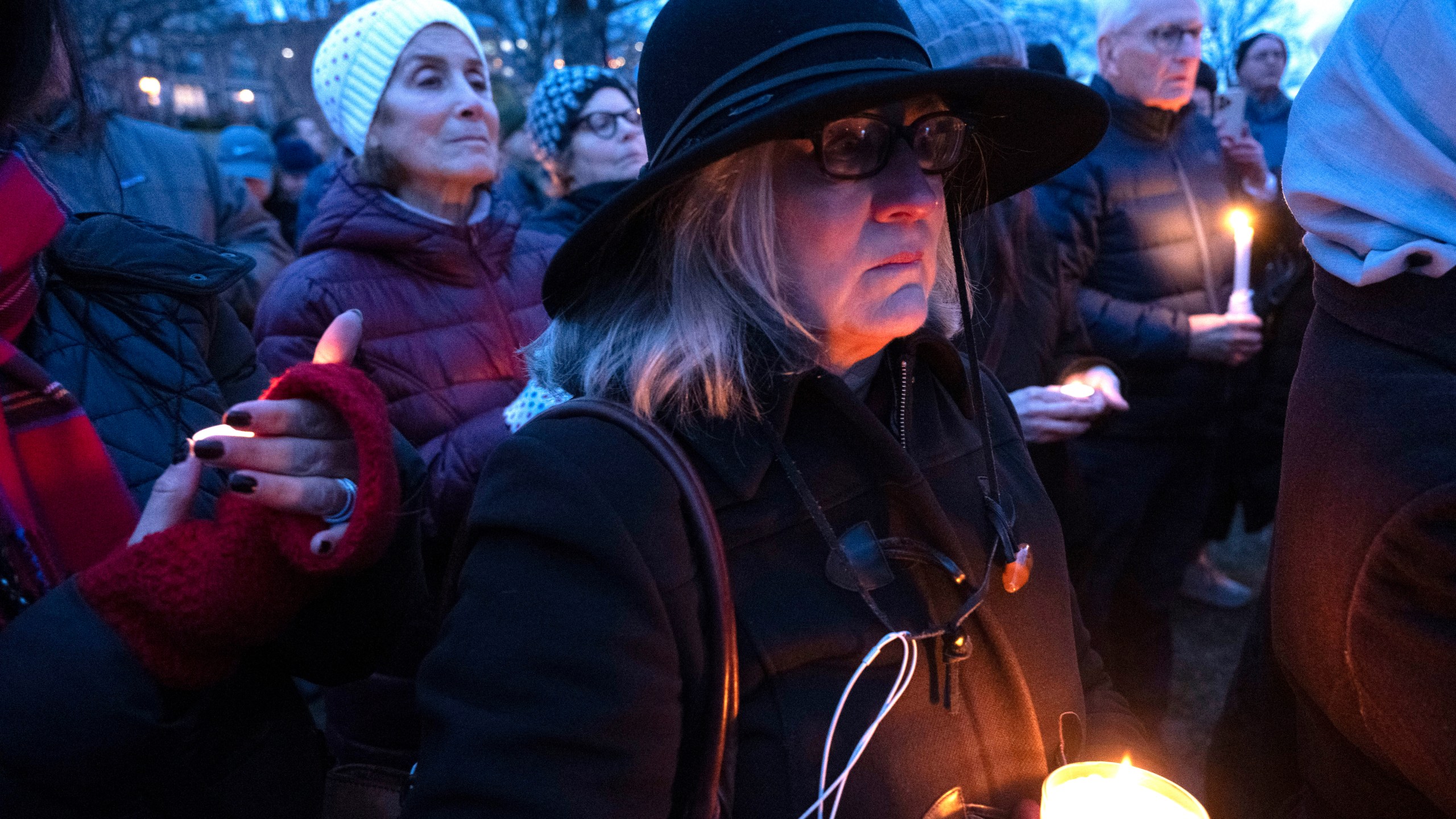 Mourners hold candles during a vigil, Wednesday, Feb. 5, 2025 in Alexandria, Va., for the victims of the mid-air collision of an American Airlines jet and a Black Hawk helicopter at Reagan National Airport. (AP Photo/Kevin Wolf)