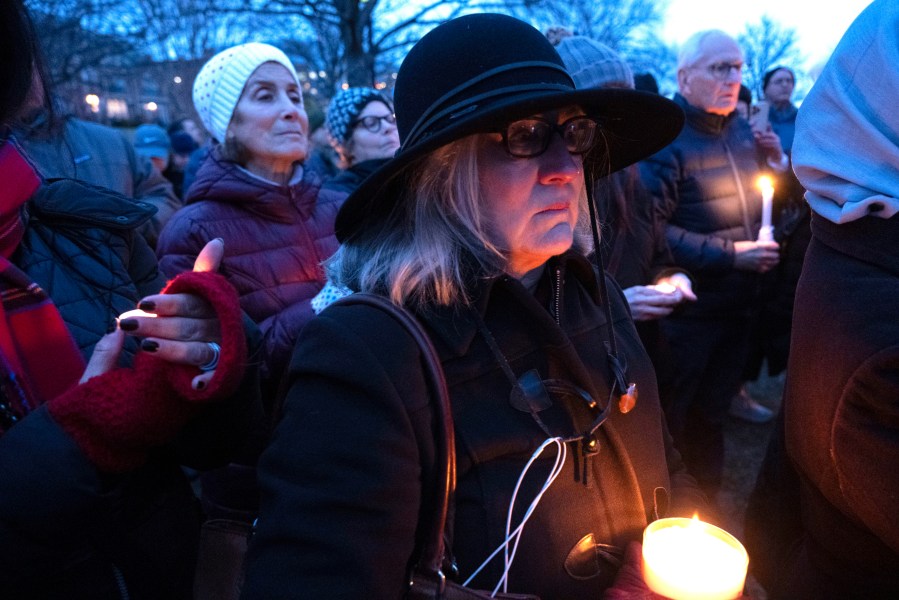 Mourners hold candles during a vigil, Wednesday, Feb. 5, 2025 in Alexandria, Va., for the victims of the mid-air collision of an American Airlines jet and a Black Hawk helicopter at Reagan National Airport. (AP Photo/Kevin Wolf)