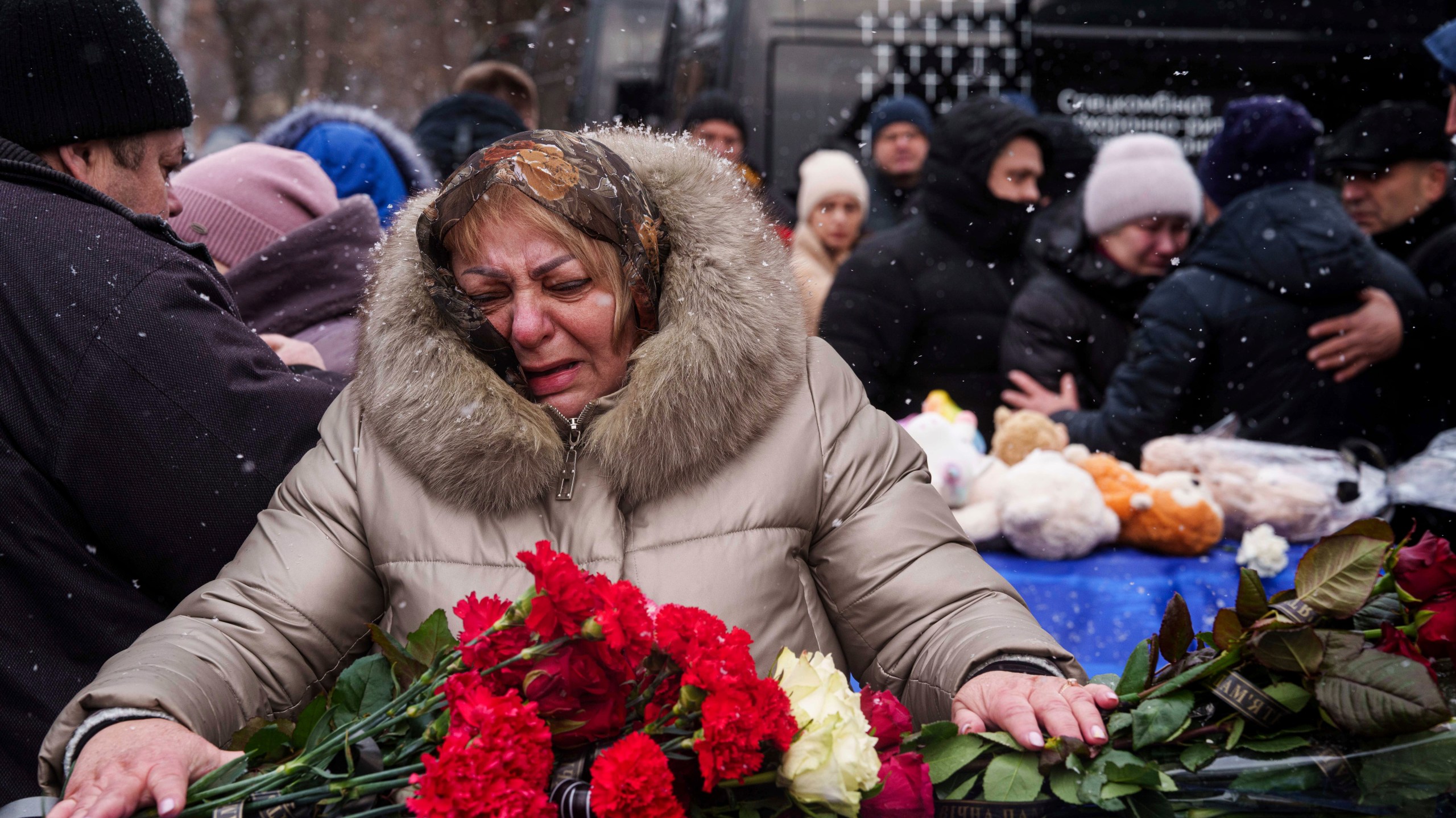 Relatives say goodbye to Dmytro Yavorskyi, 37, Sofia Yavorska, 9, Olena Yavorska 38, who were killed on Feb. 1 by a Russian strike on residential building during a funeral ceremony in Poltava, Ukraine, Wednesday, Feb. 5, 2025. (AP Photo/Evgeniy Maloletka)