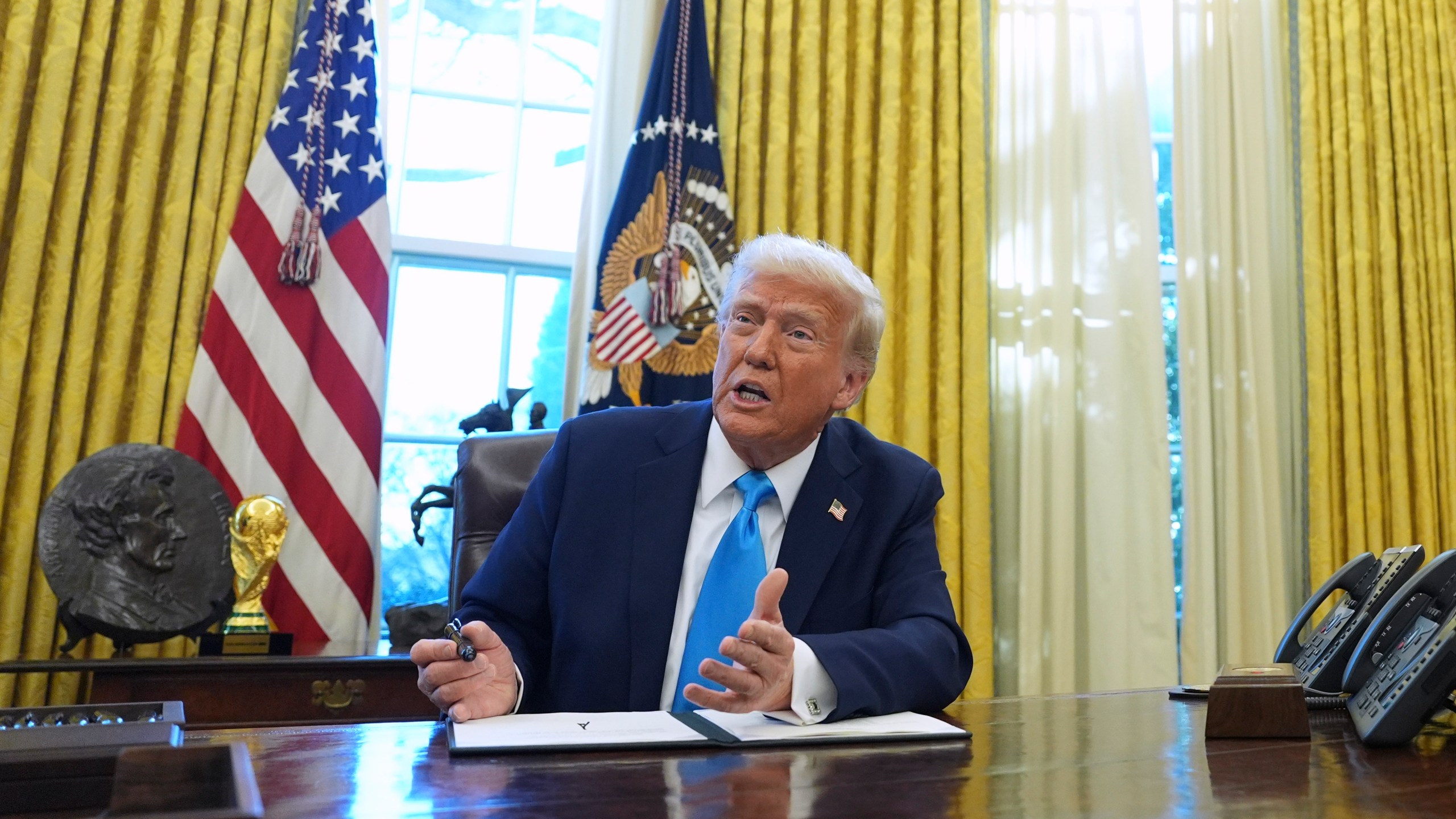 FILE - President Donald Trump speaks to reporters as he signs executive orders in the White House on Tuesday, Feb. 4, 2025, in Washington. (AP Photo/Evan Vucci, File)