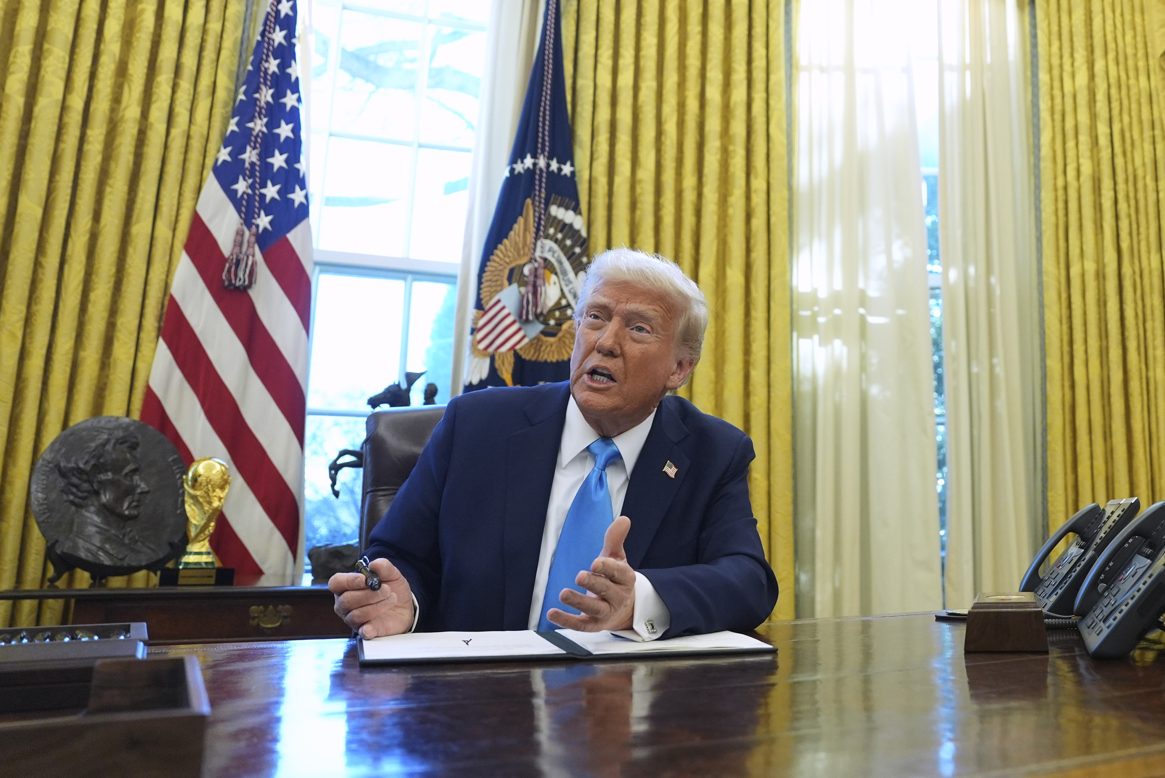 FILE - President Donald Trump speaks to reporters as he signs executive orders in the White House on Tuesday, Feb. 4, 2025, in Washington. (AP Photo/Evan Vucci, File)