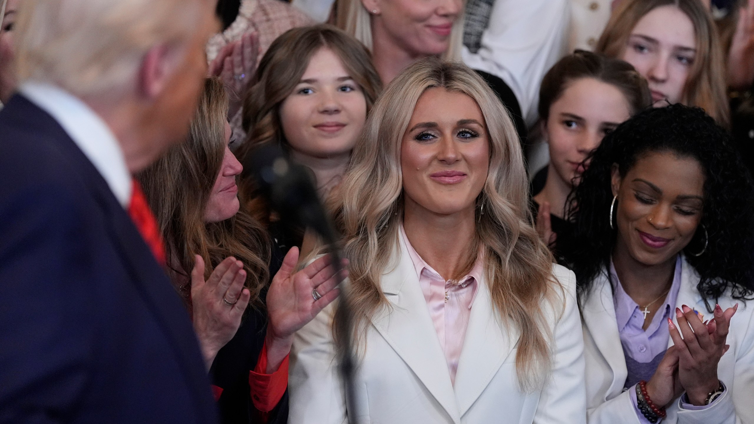 President Donald Trump acknowledges Riley Gaines as he speaks before signing an executive order barring transgender female athletes from competing in women's or girls' sporting events, in the East Room of the White House, Wednesday, Feb. 5, 2025, in Washington. (AP Photo/Alex Brandon)