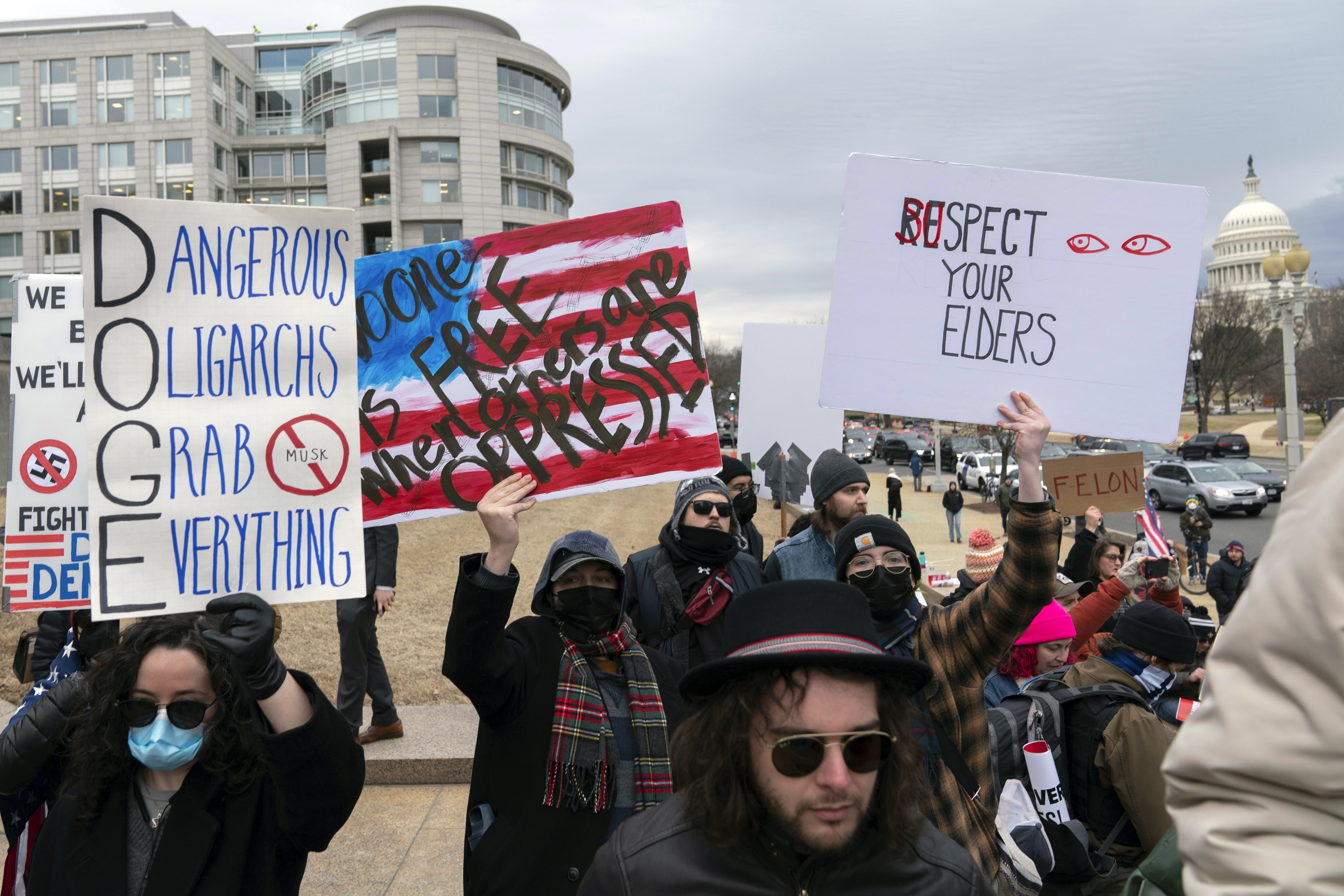 People protest during a rally against Elon Musk outside the U.S. Department of Labor in Washington, Wednesday, Feb. 5, 2025. (AP Photo/Jose Luis Magana)