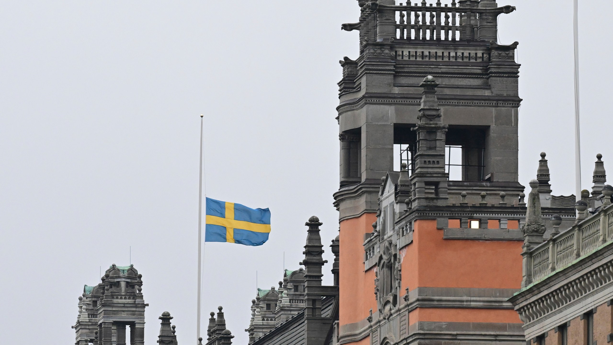 A Swedish flag flies at half-mast at Rosenbad, Sweden's Government Offices in Stockholm, Wednesday Feb. 5, 2025, after a shooting at an adult education center on Tuesday. (Jonas Ekströmer/TT via AP)