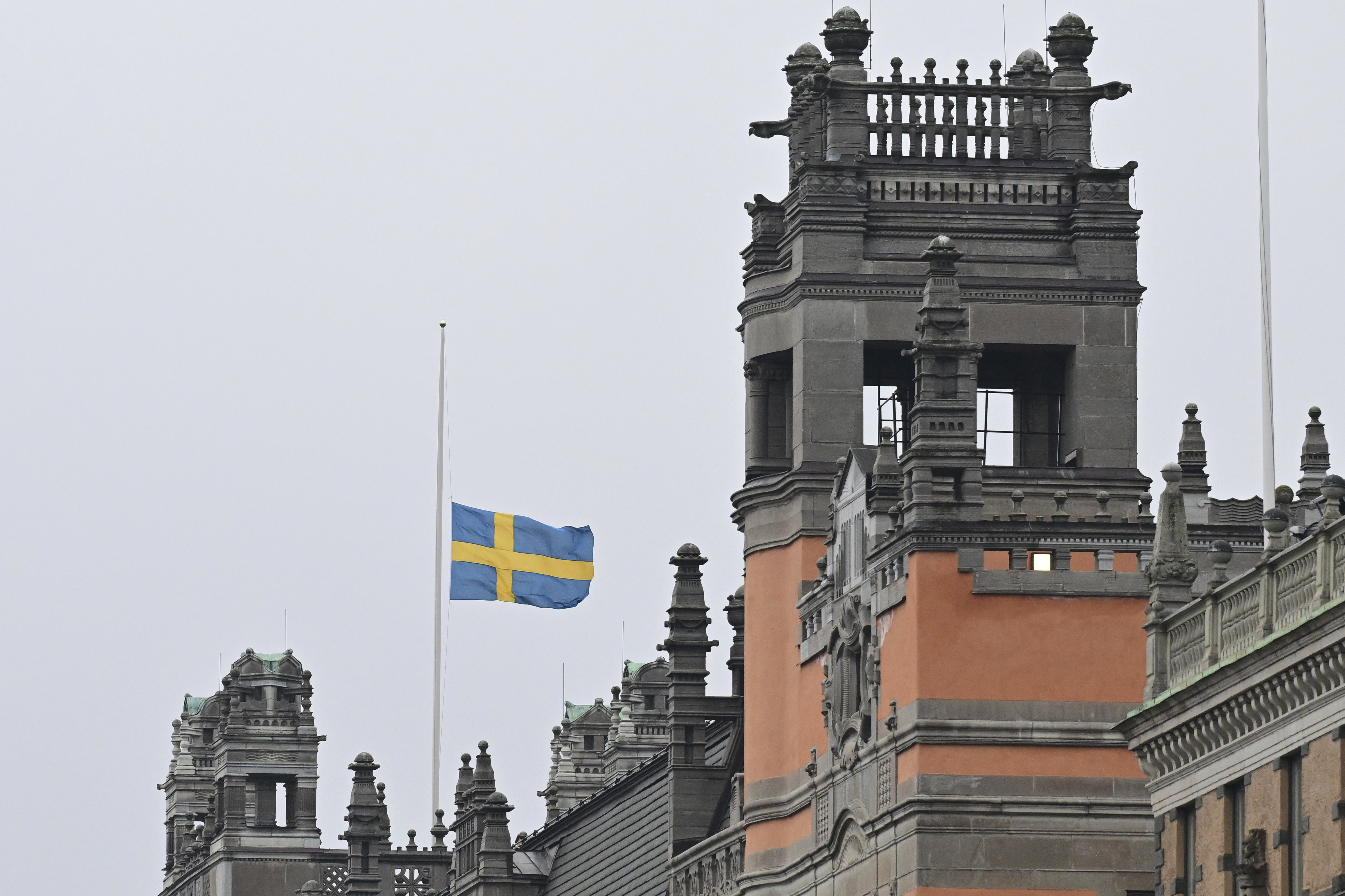 A Swedish flag flies at half-mast at Rosenbad, Sweden's Government Offices in Stockholm, Wednesday Feb. 5, 2025, after a shooting at an adult education center on Tuesday. (Jonas Ekströmer/TT via AP)