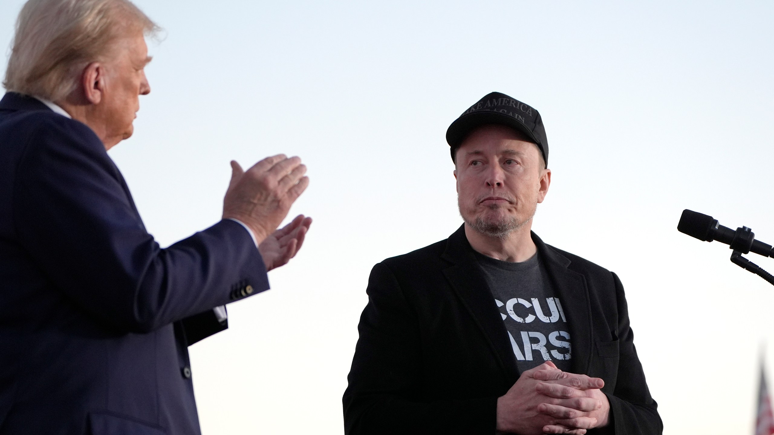 FILE - Republican presidential nominee former President Donald Trump, left, claps as Tesla and SpaceX CEO Elon Musk prepares to depart after speaking at a campaign event at the Butler Farm Show, on Oct. 5, 2024, in Butler, Pa. (AP Photo/Alex Brandon, File)