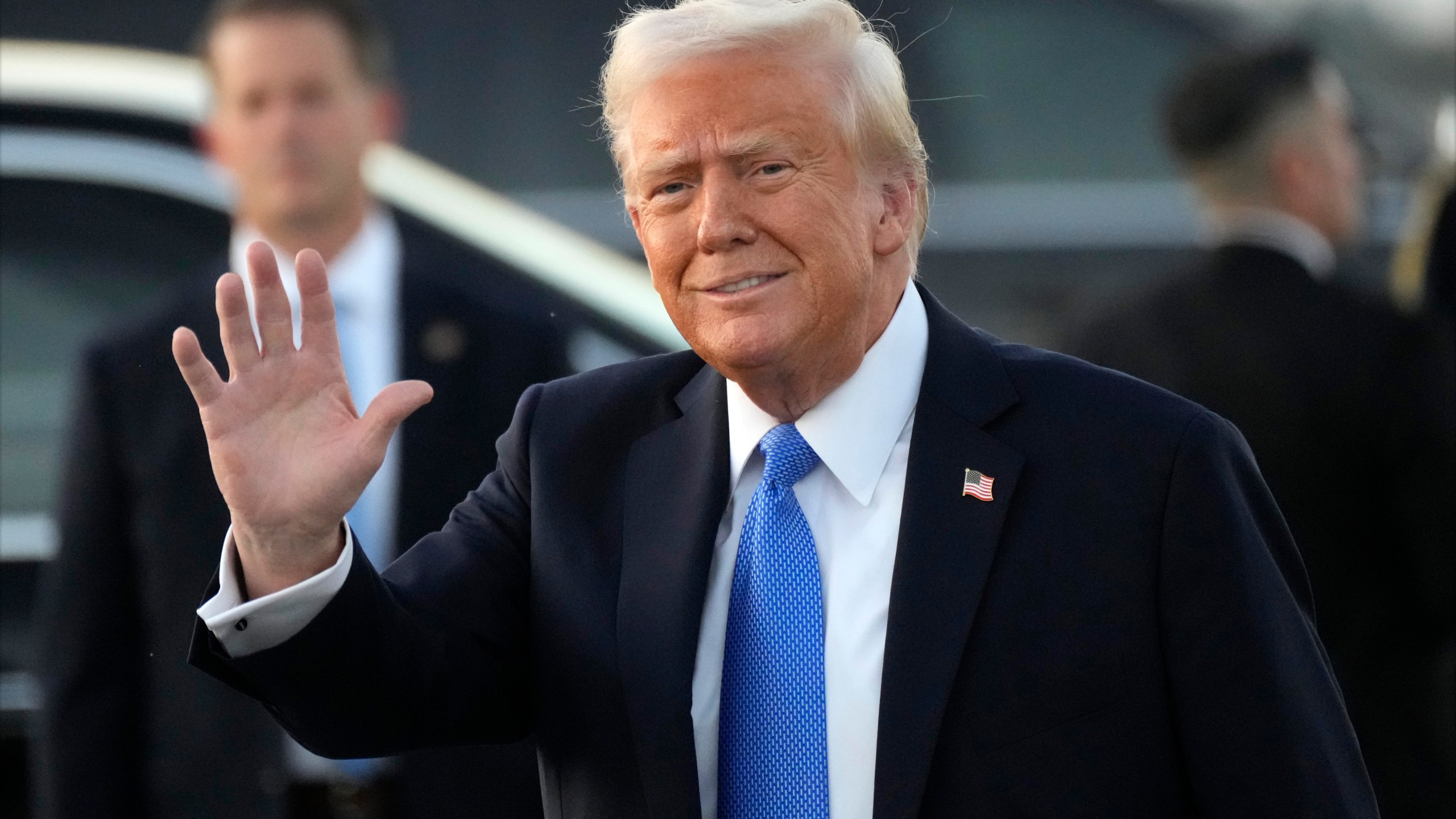 President Donald Trump waves after arriving on Air Force One at Palm Beach International Airport in West Palm Beach, Fla., Friday, Feb. 7, 2025. (AP Photo/Ben Curtis)