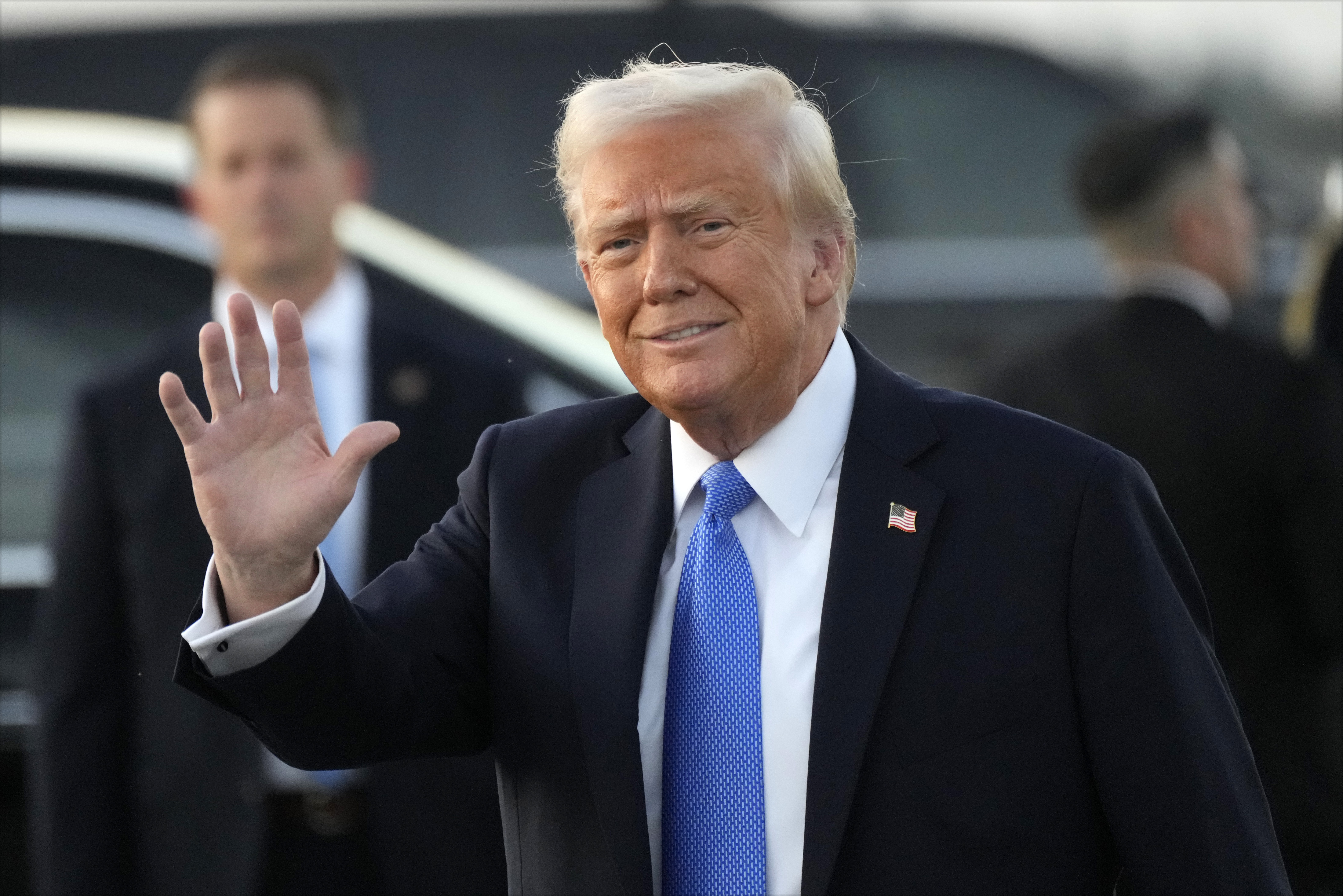 President Donald Trump waves after arriving on Air Force One at Palm Beach International Airport in West Palm Beach, Fla., Friday, Feb. 7, 2025. (AP Photo/Ben Curtis)