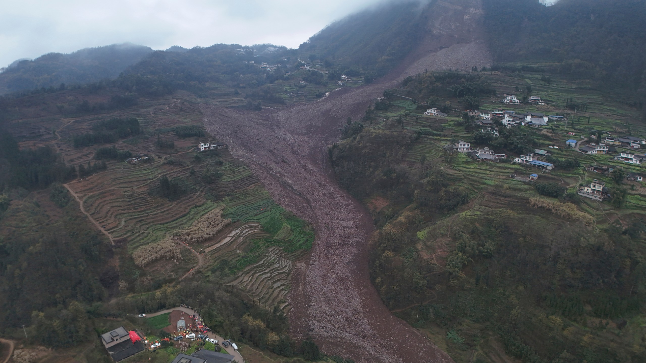 In this photo released by Xinhua News Agency, an aerial drone photo shows the site of a landslide in Jinping Village, Junlian County in the city of Yibin, southwest China's Sichuan Province, Saturday Feb. 8, 2025. (Zeng Li/Xinhua via AP)