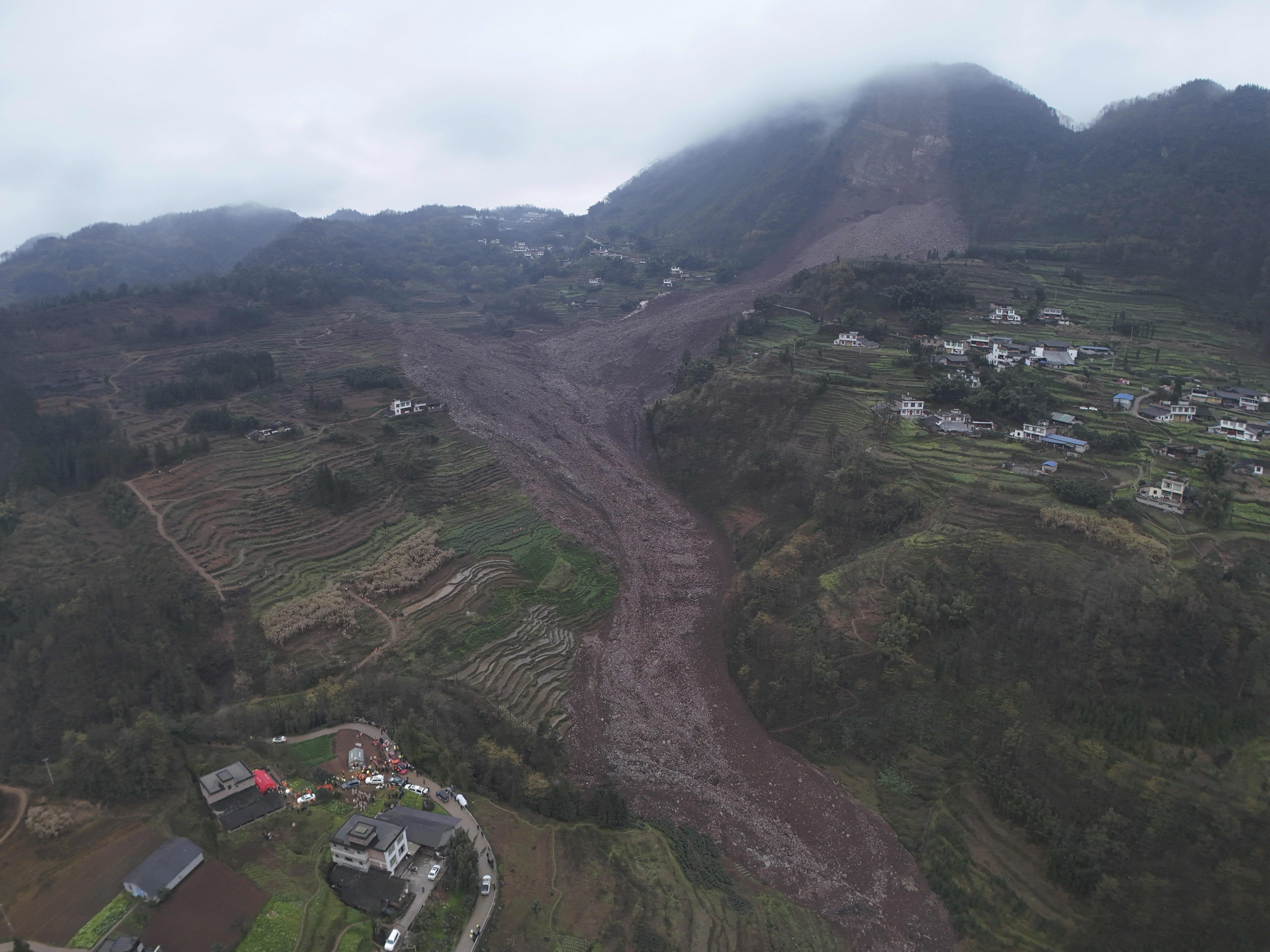 In this photo released by Xinhua News Agency, an aerial drone photo shows the site of a landslide in Jinping Village, Junlian County in the city of Yibin, southwest China's Sichuan Province, Saturday Feb. 8, 2025. (Zeng Li/Xinhua via AP)