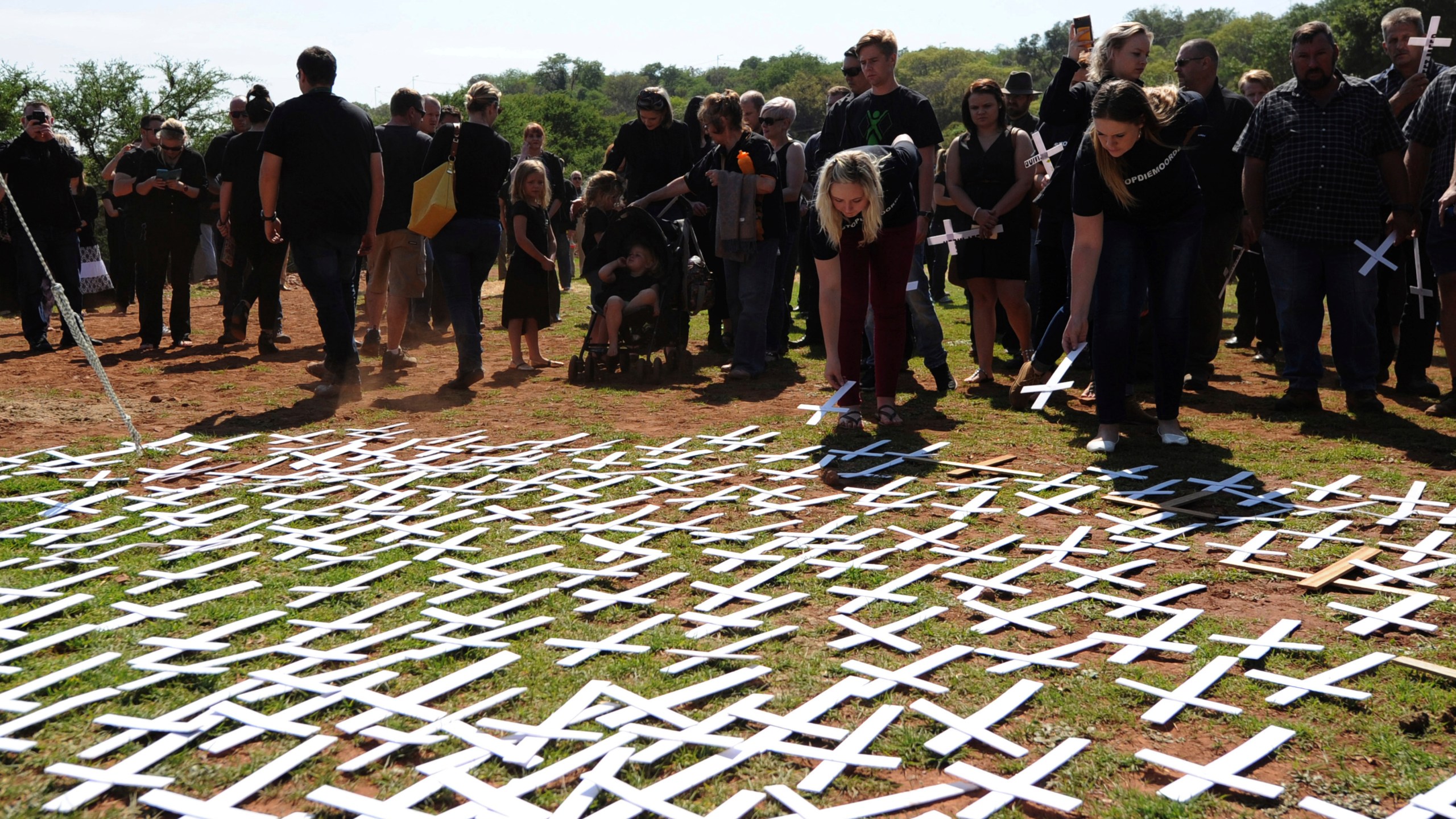 FILE - People place white crosses representing farmers killed in the country at a ceremony at the Vorrtrekker Monument in Pretoria, South Africa, Oct. 30, 2017. (AP Photo, File)