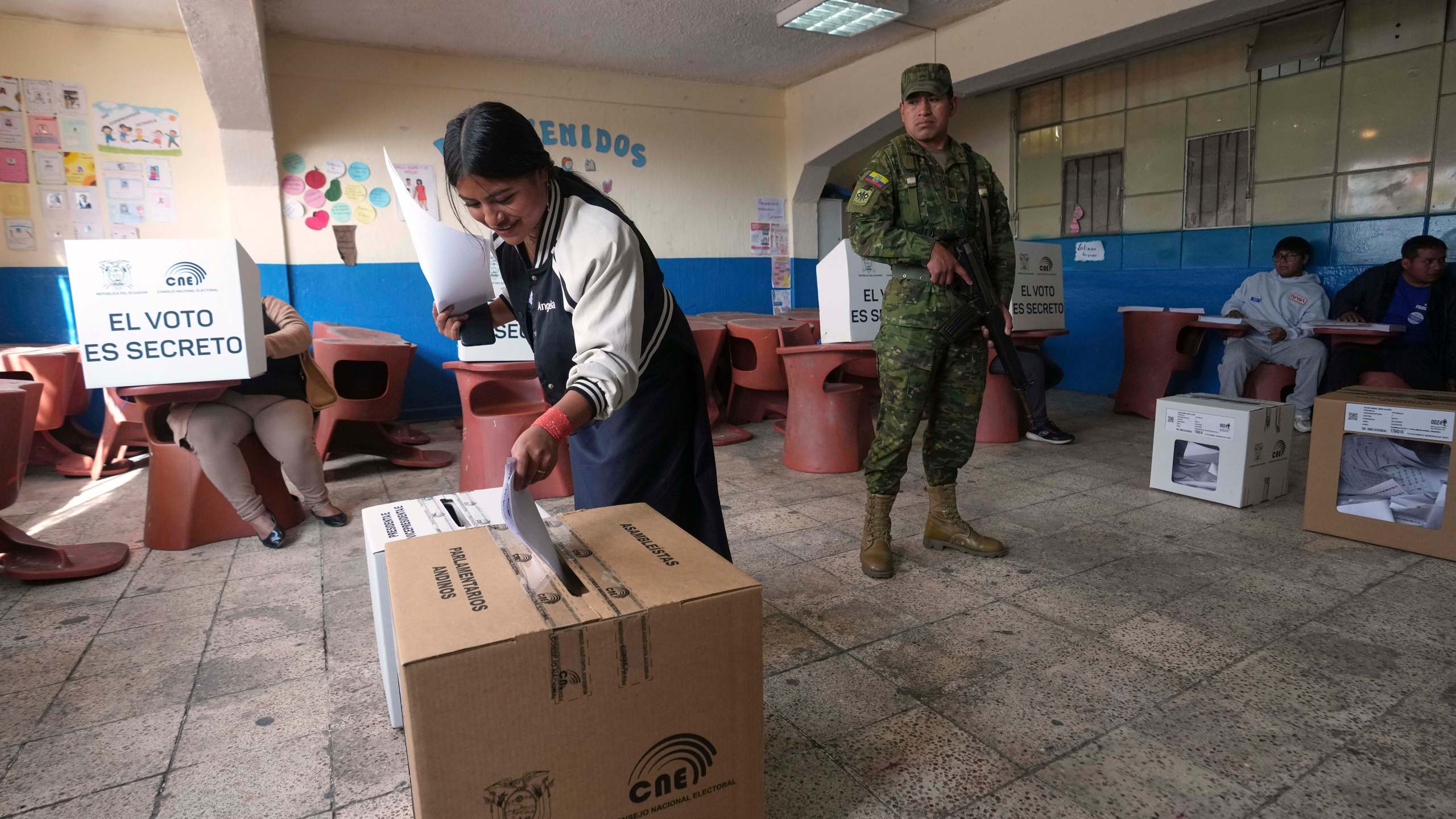 A voter casts her ballot during the presidential election in Quito, Ecuador, Sunday, Feb. 9, 2025. (AP Photo/Dolores Ochoa)