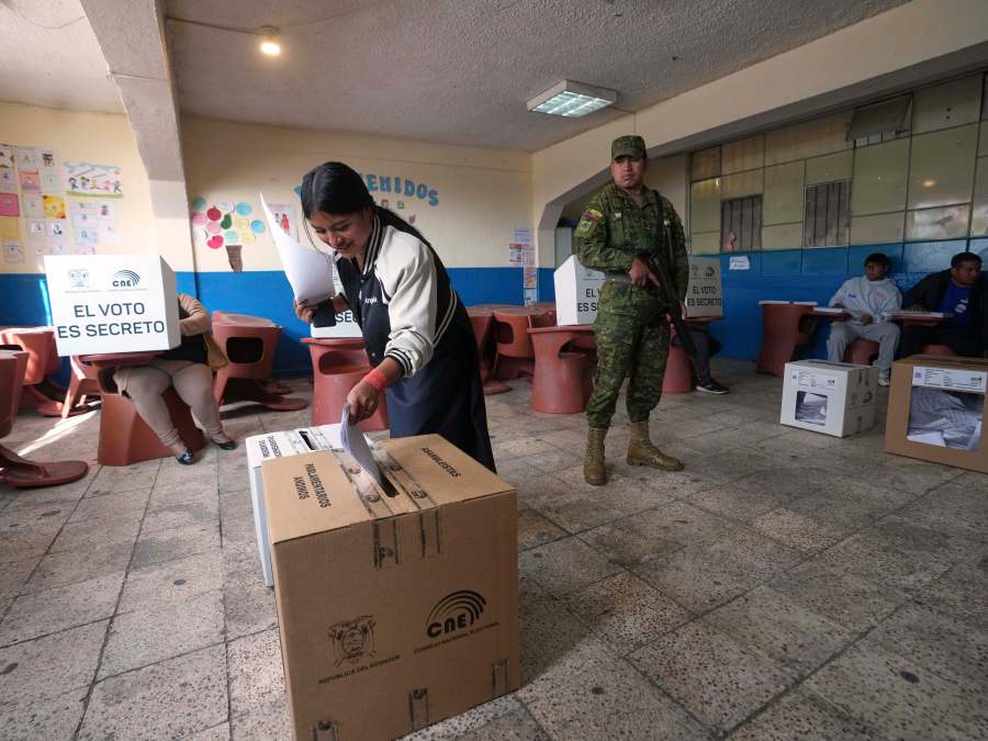 A voter casts her ballot during the presidential election in Quito, Ecuador, Sunday, Feb. 9, 2025. (AP Photo/Dolores Ochoa)