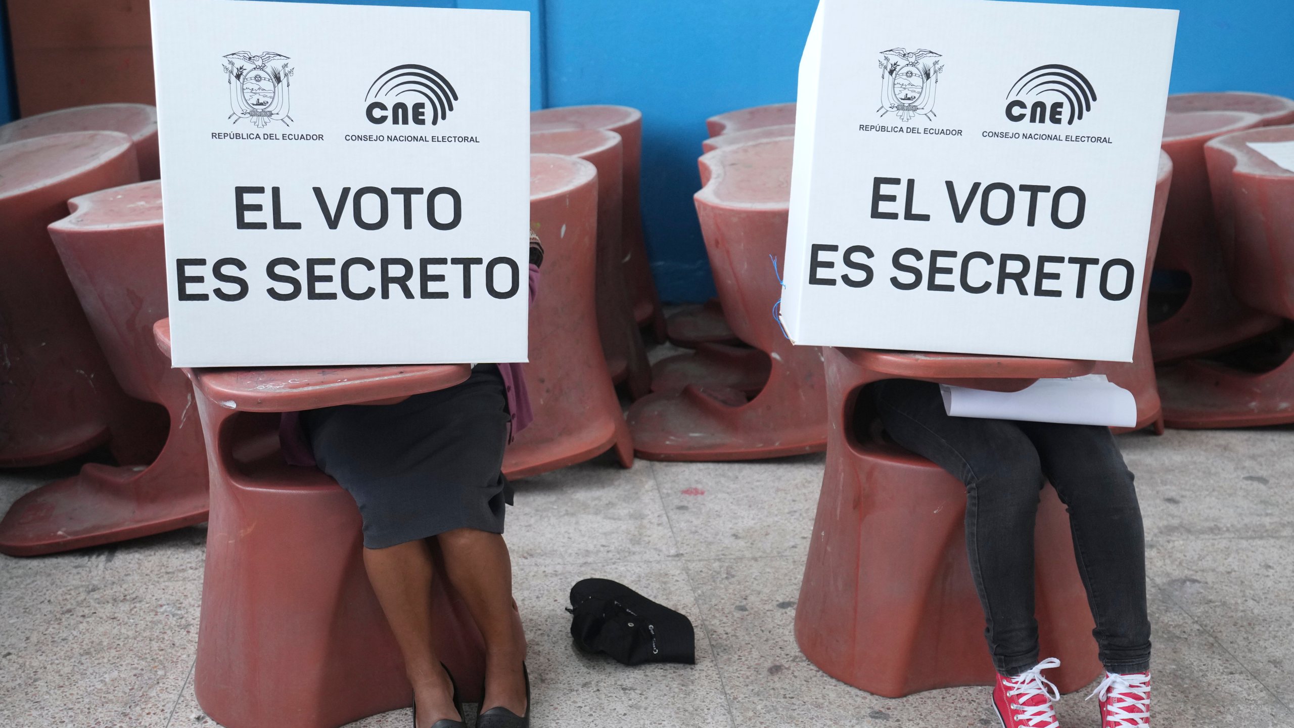 Voters mark ballots for their candidate of choice during the presidential election in Quito, Ecuador, Sunday, Feb. 9, 2025. (AP Photo/Dolores Ochoa)