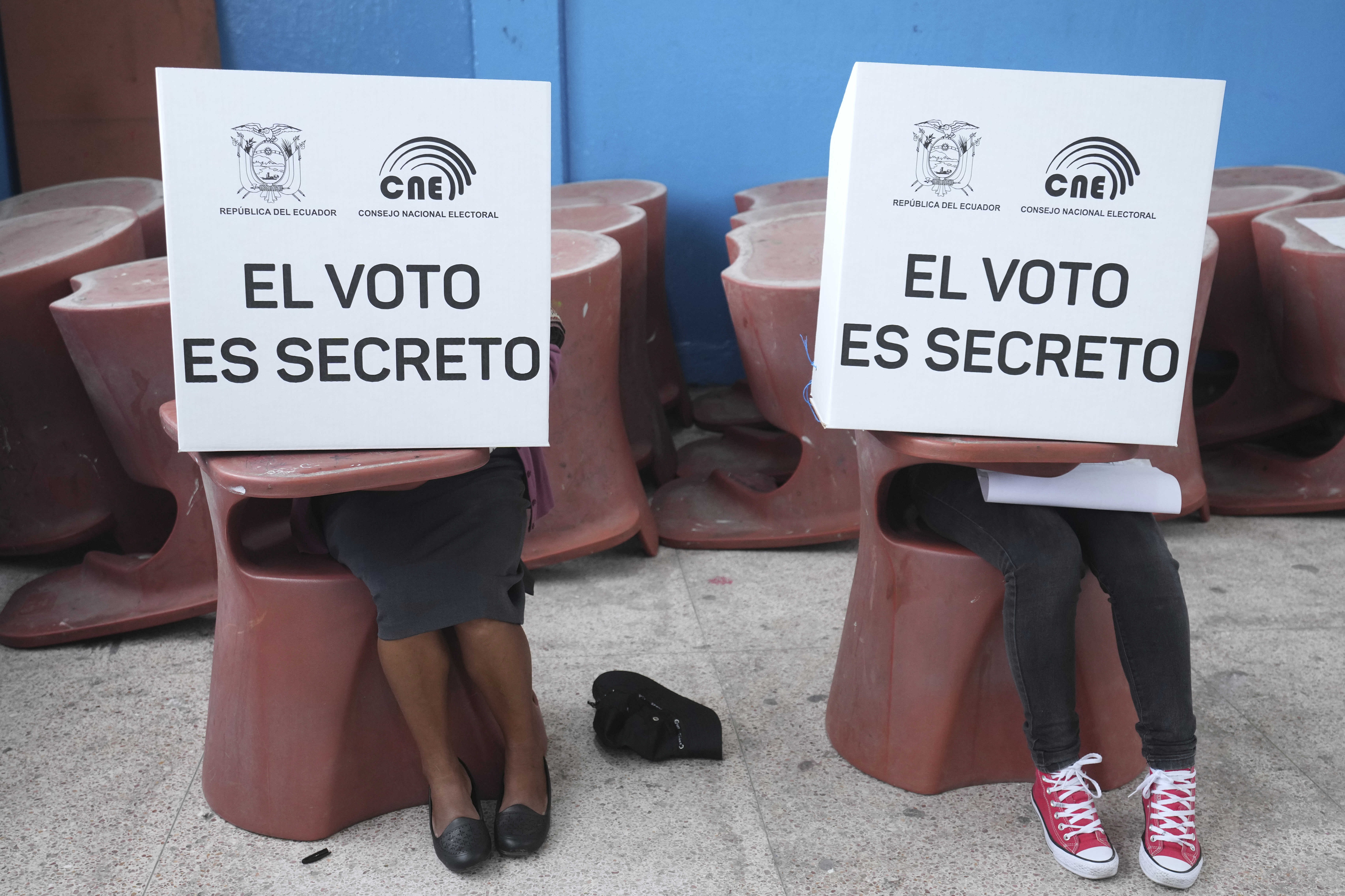 Voters mark ballots for their candidate of choice during the presidential election in Quito, Ecuador, Sunday, Feb. 9, 2025. (AP Photo/Dolores Ochoa)