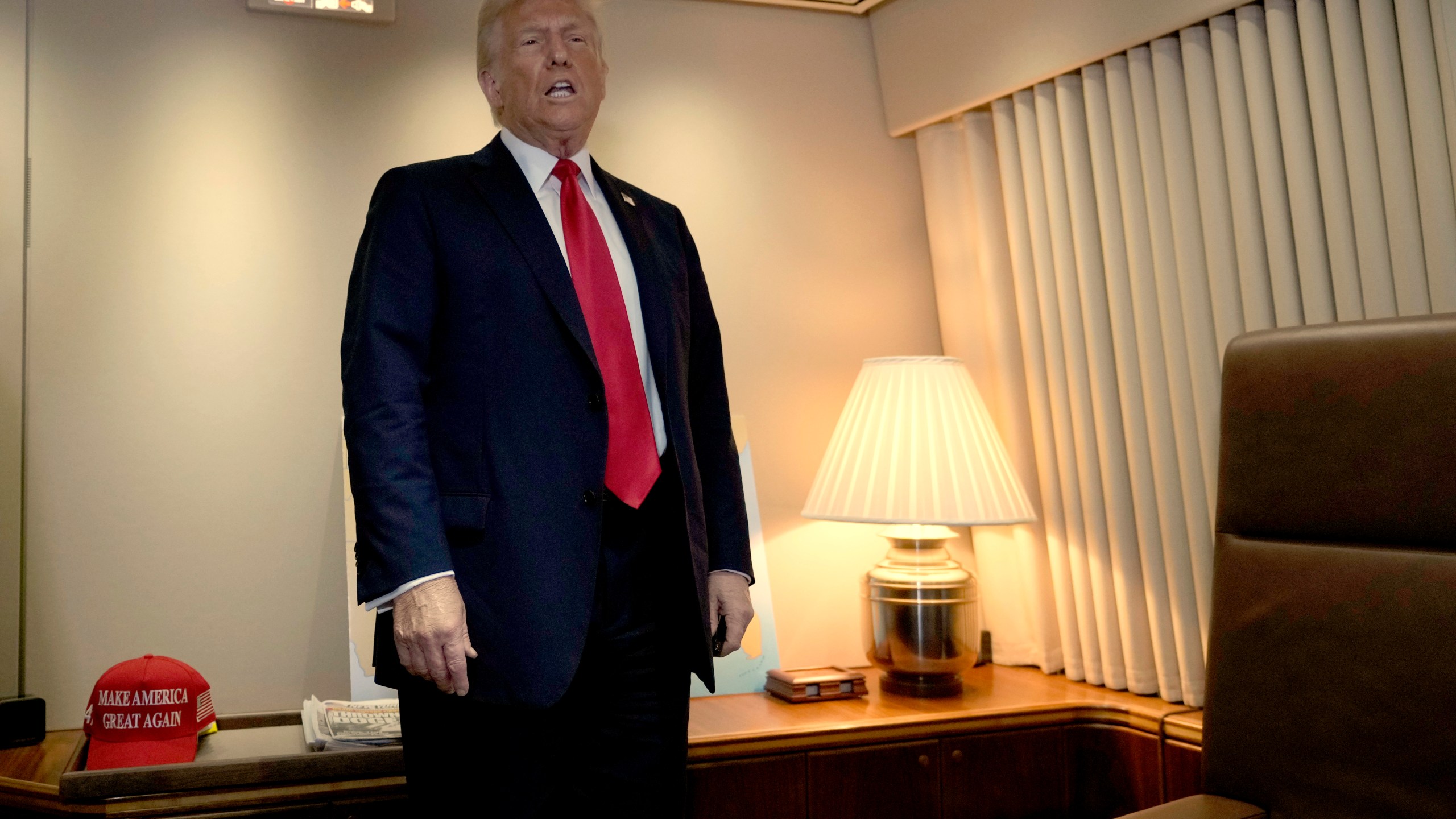 President Donald Trump speaks to reporters aboard Air Force One as he prepares to sign a proclamation declaring Feb. 9 Gulf of America Day as he travels from West Palm Beach, Fla. to New Orleans, Sunday, Feb. 9, 2025. (AP Photo/Ben Curtis)