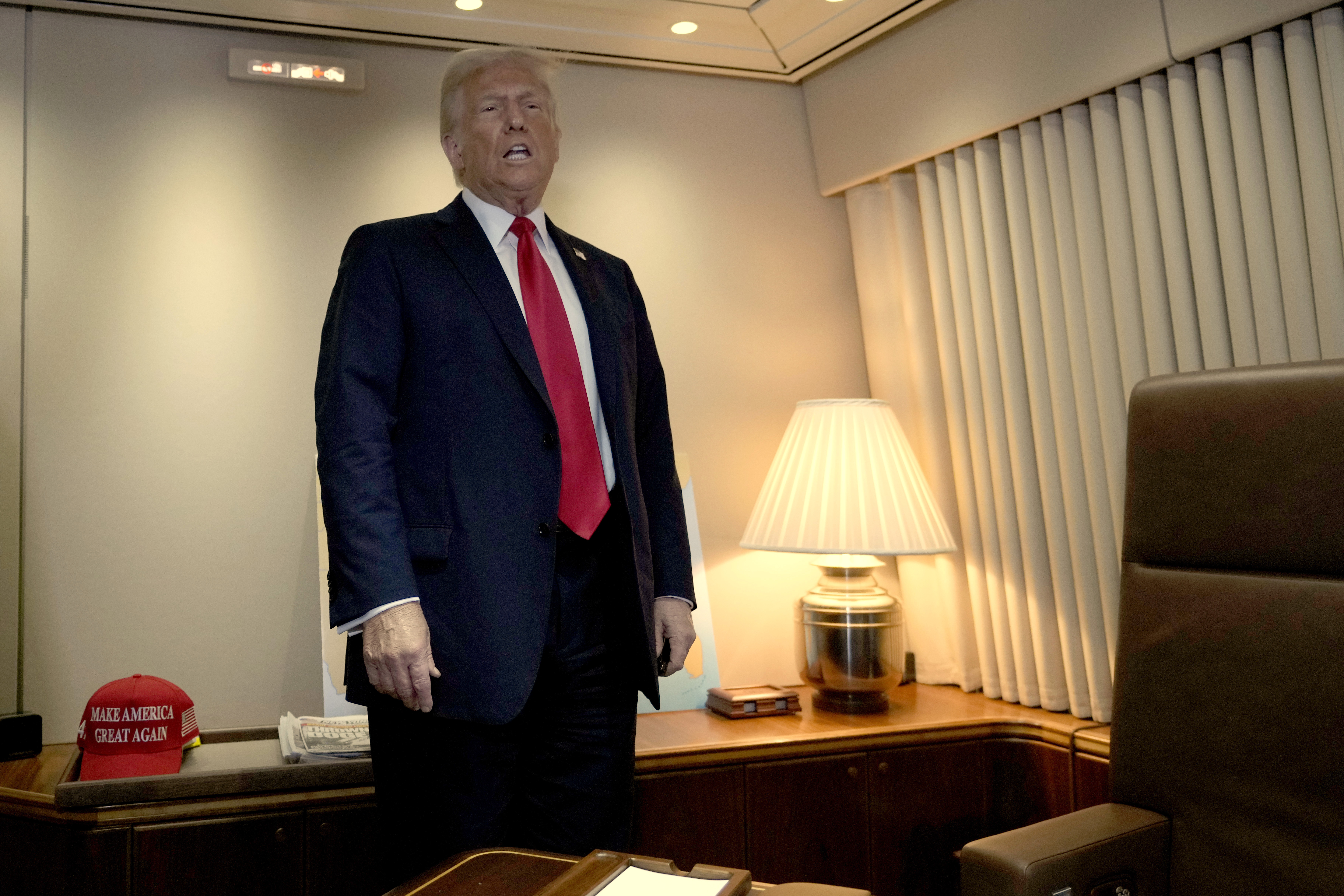 President Donald Trump speaks to reporters aboard Air Force One as he prepares to sign a proclamation declaring Feb. 9 Gulf of America Day as he travels from West Palm Beach, Fla. to New Orleans, Sunday, Feb. 9, 2025. (AP Photo/Ben Curtis)