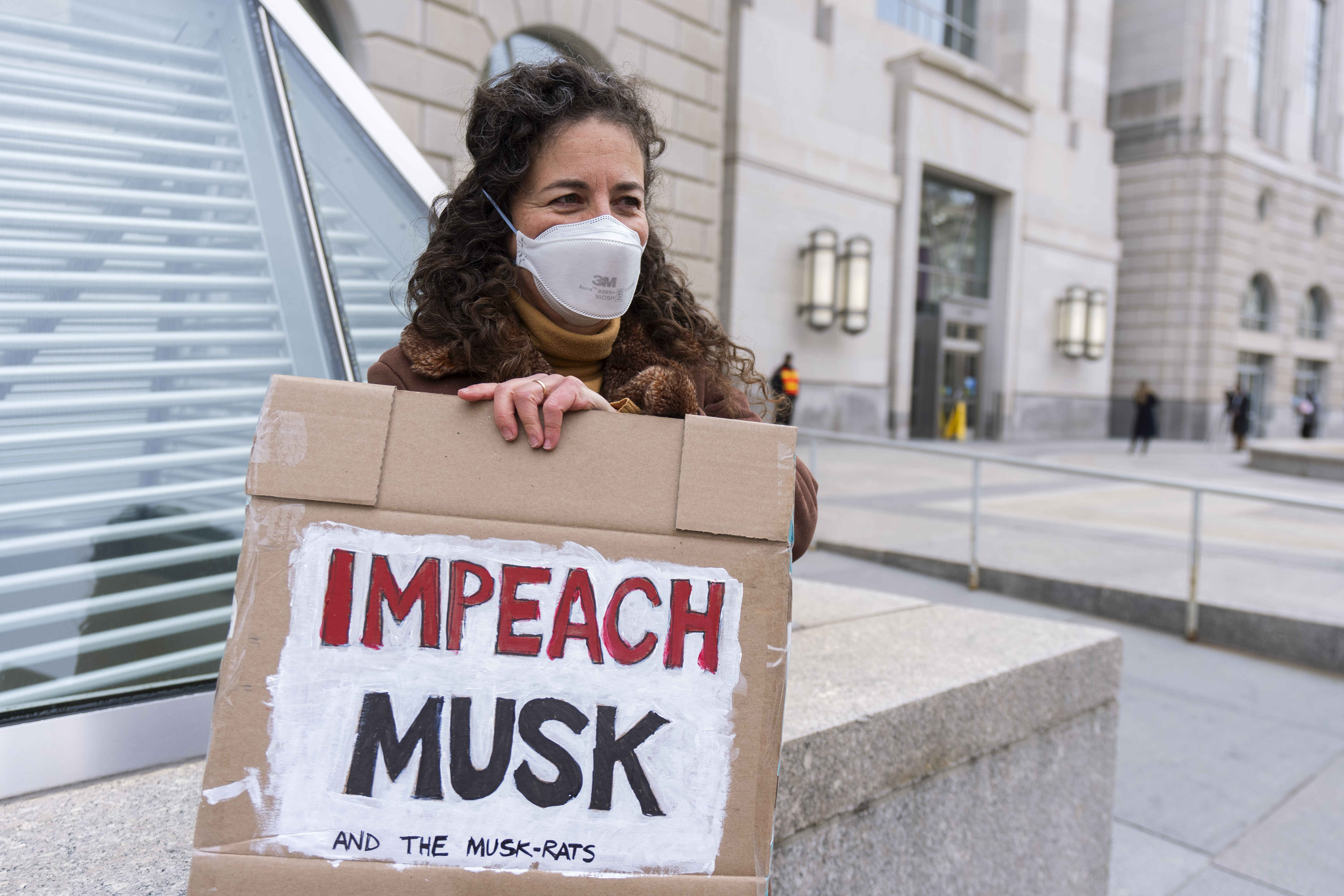 A United States Agency for International Development, or USAID contract worker, carries a sign outside the USAID headquarters in Washington, Monday, Feb. 10, 2025. (AP Photo/Manuel Balce Ceneta)