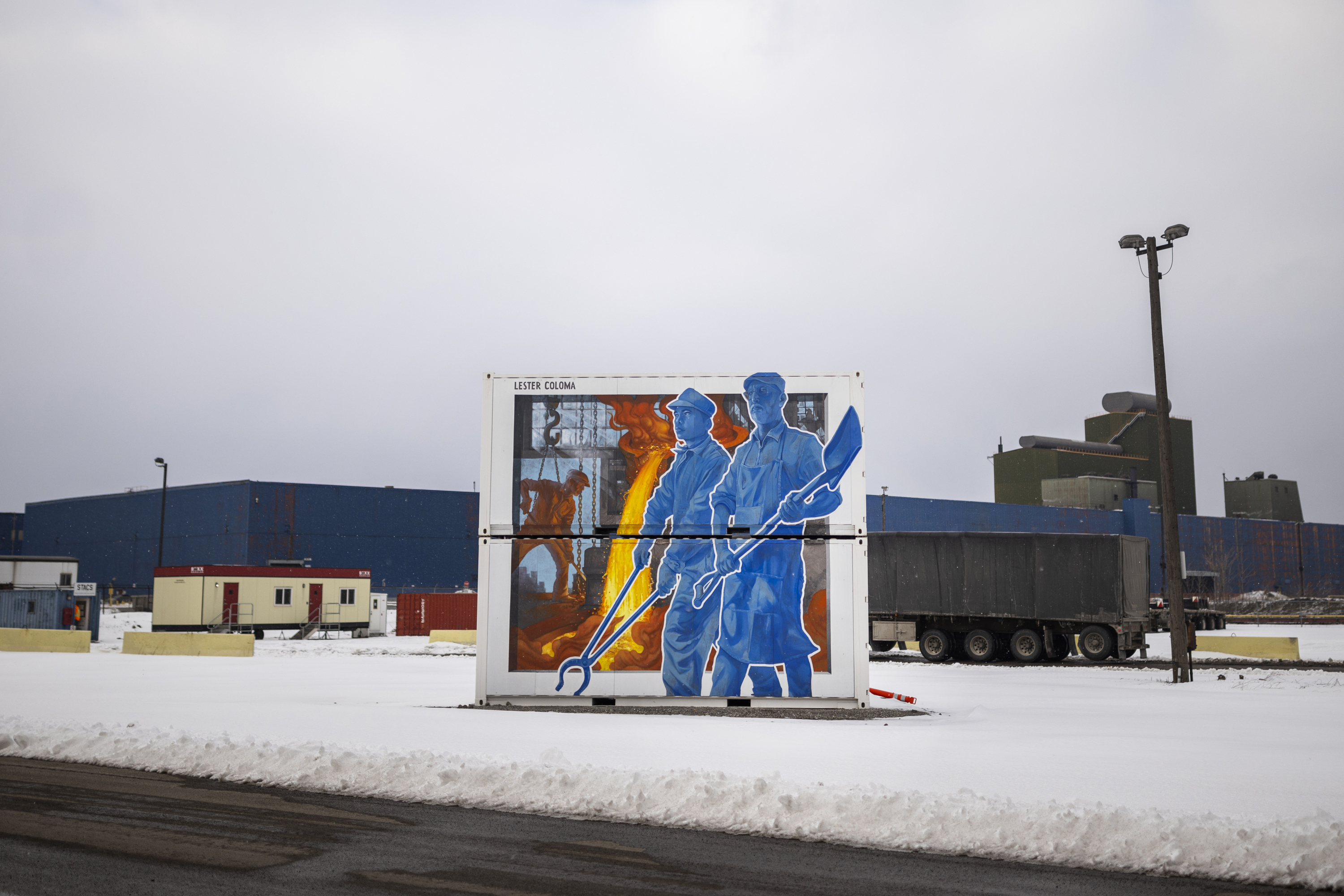 A mural depicting steel workers stands at the Stelco steel production facility in Hamilton, Ontario, on Monday, Feb. 10, 2025. (Nick Iwanyshyn/The Canadian Press via AP)