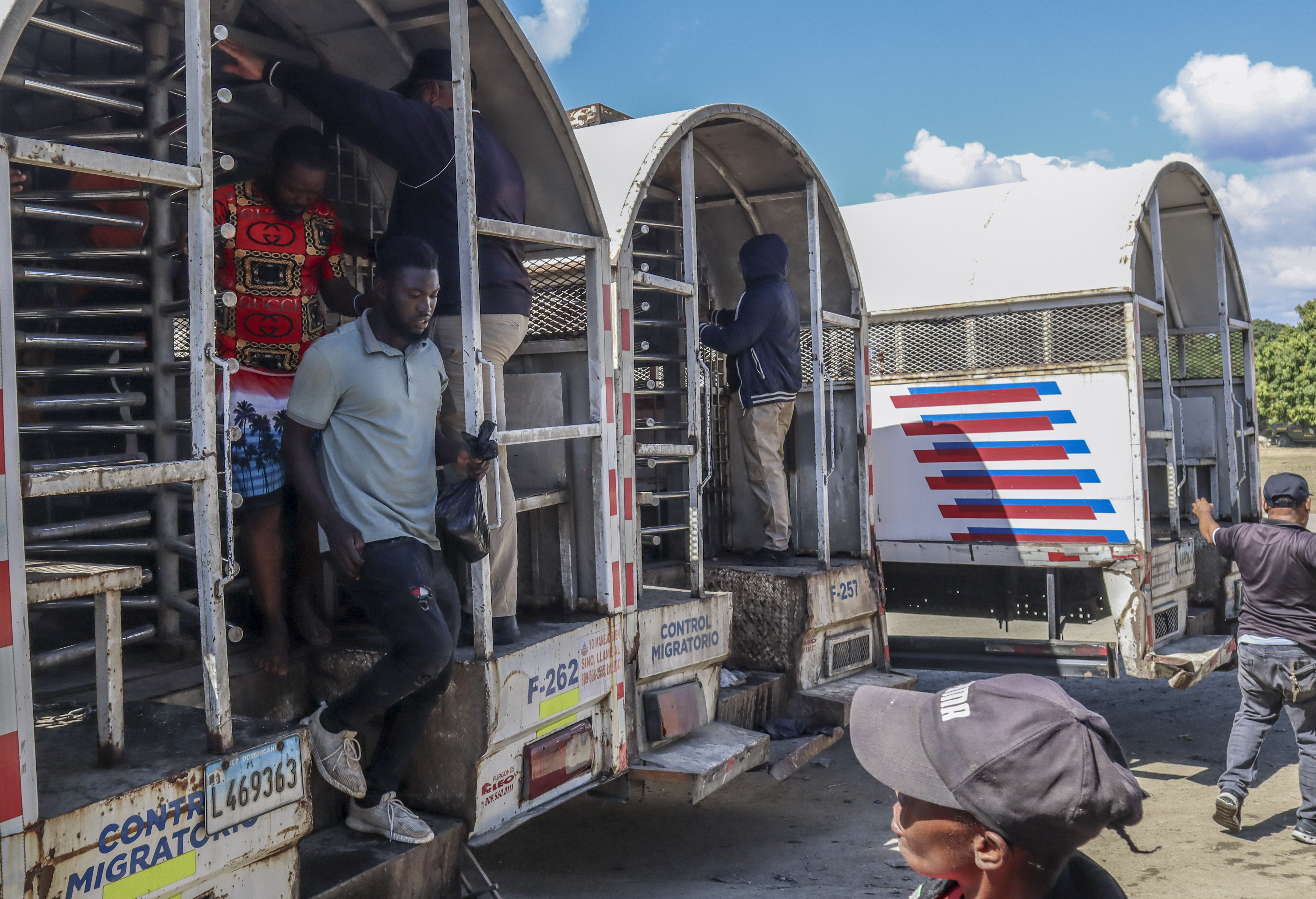 Haitians deported from the Dominican Republic get out of trucks in Carrizal, Dominican Republic, on the border with Haiti, Thursday, Jan. 30, 2025. (AP Photo/Martin Adames)