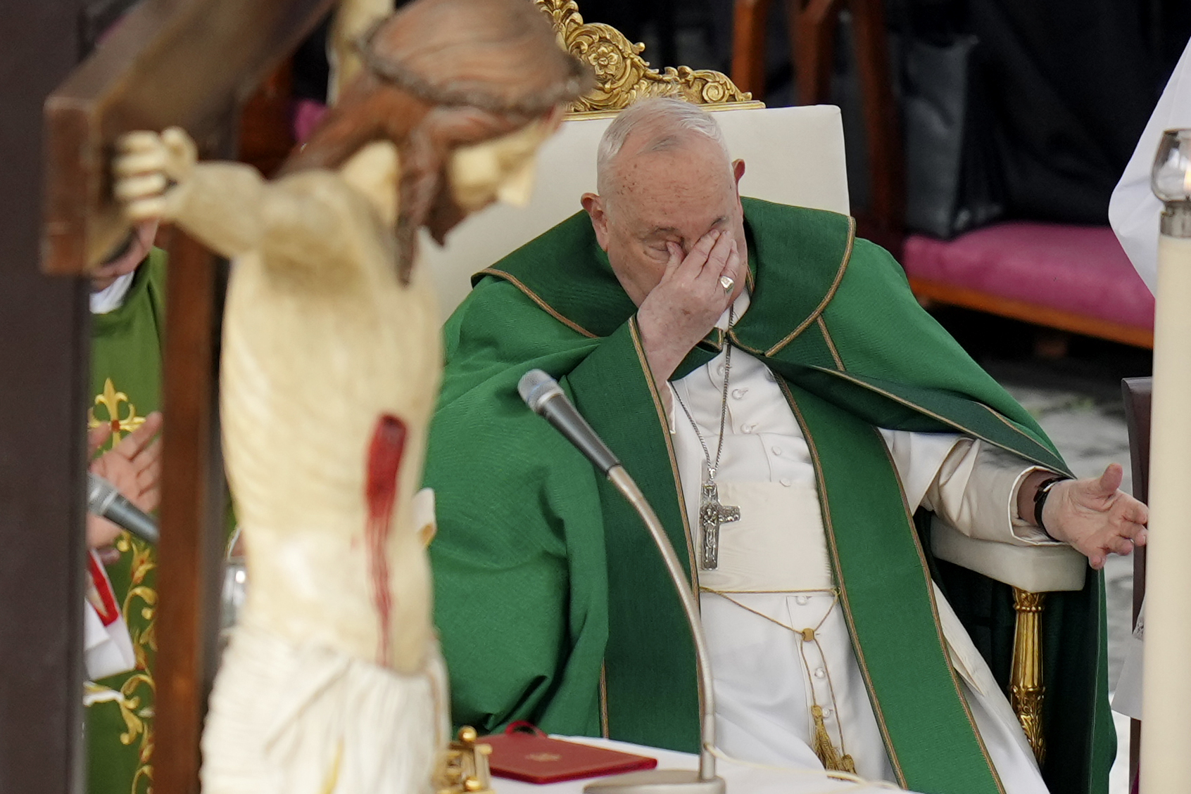 Pope Francis touches his eyes as he presides over a mass for the jubilee of the armed forces in St. Peter's Square at The Vatican, Sunday Feb.9, 2025. (AP Photo/Alessandra Tarantino)